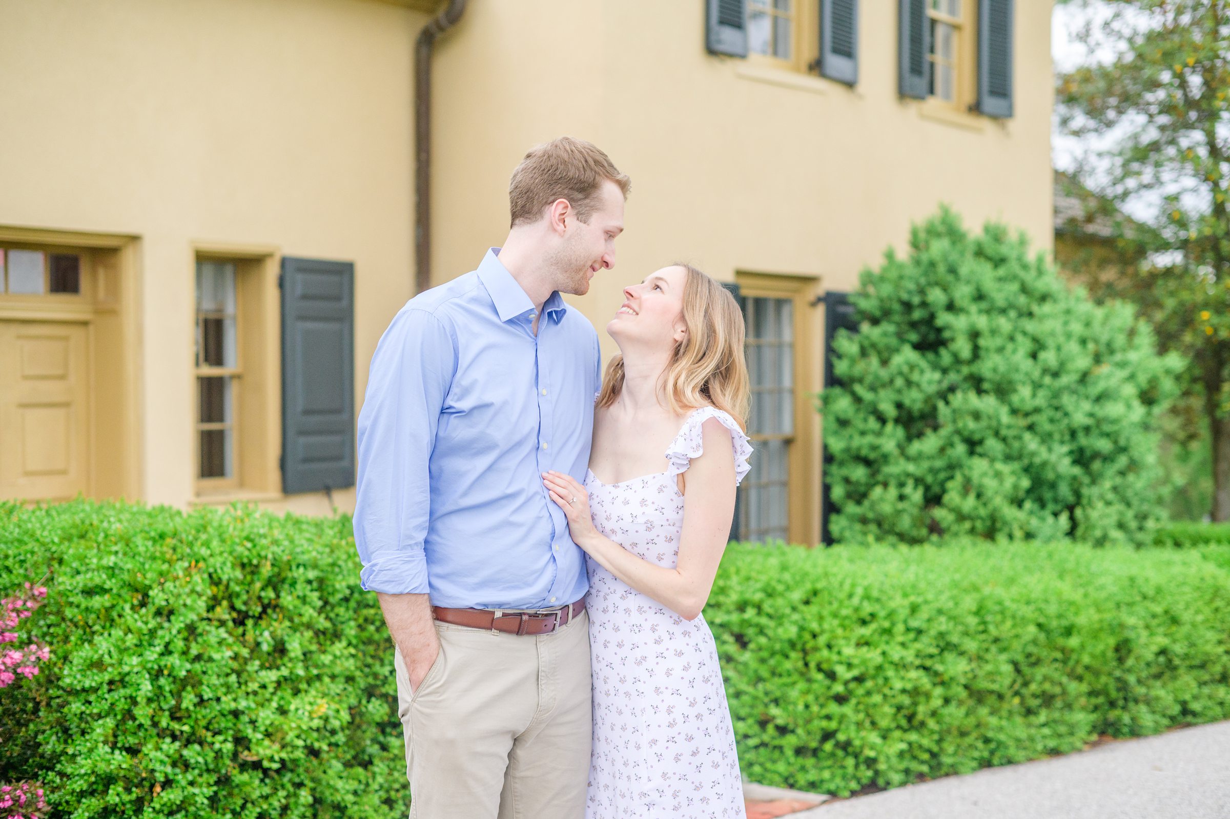 Engaged Couple poses on the lawn at Belmont Manor during a rainy sunset engagement photographed by Baltimore Wedding Photographer Cait Kramer