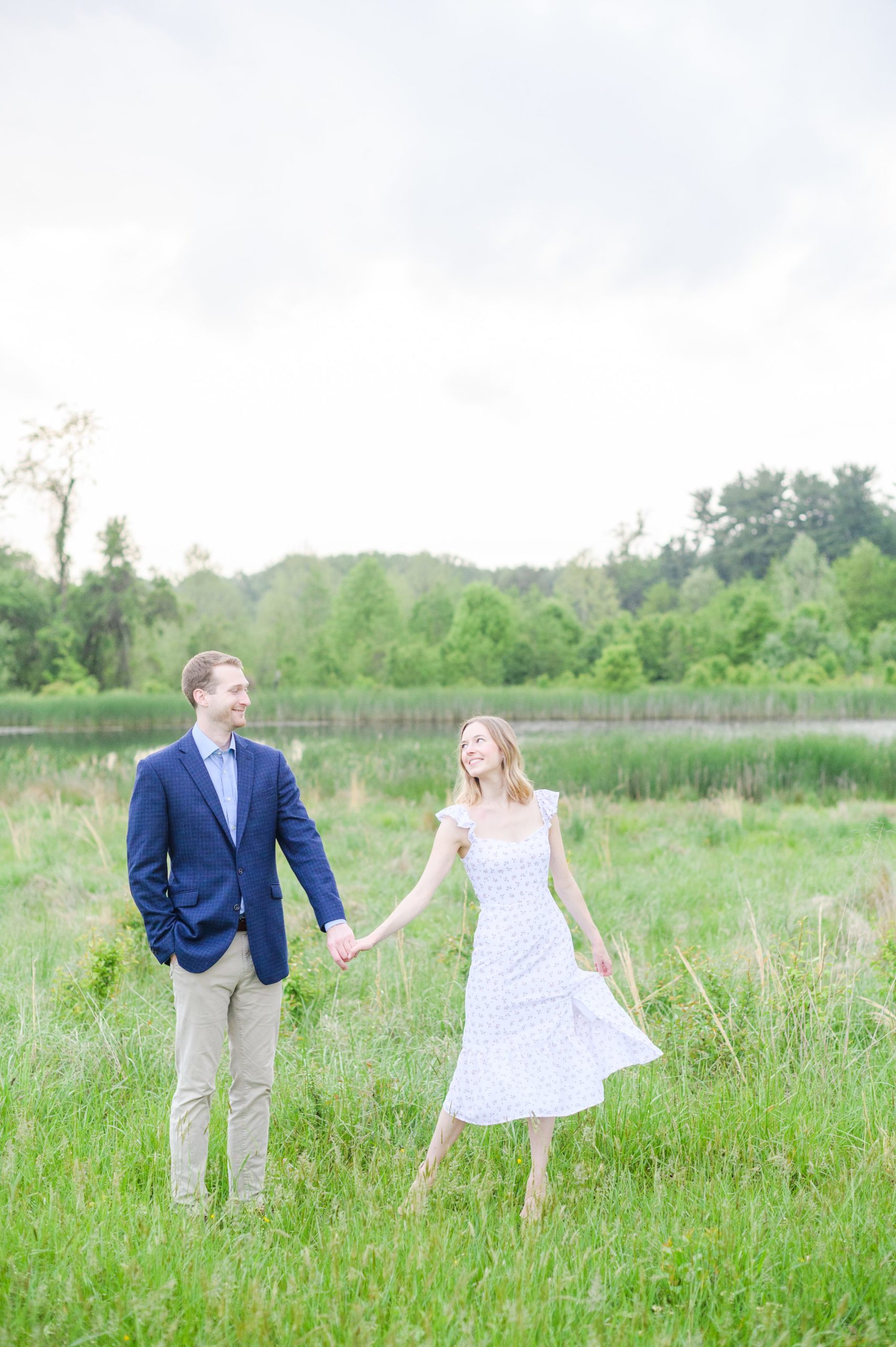 Engaged Couple poses in the fields near Belmont Manor during a rainy sunset engagement photographed by Baltimore Wedding Photographer Cait Kramer