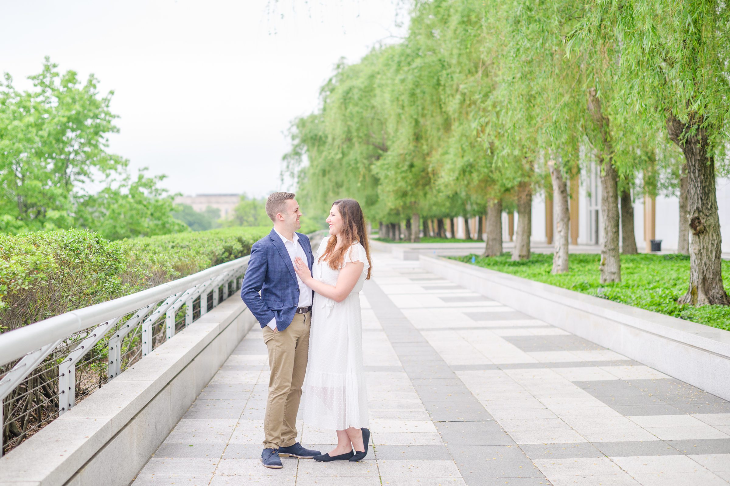 Engaged couple smiles in Foggy Bottom during engagement session at the Kennedy Center photographed by Baltimore Wedding Photographer Cait Kramer Photography