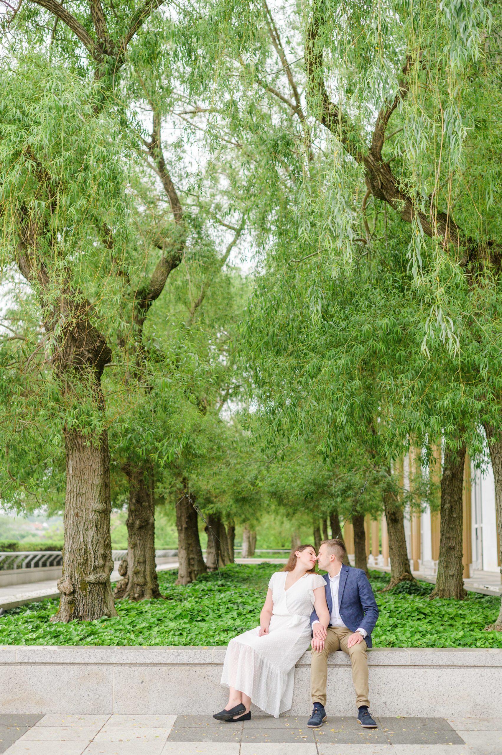 Engaged couple smiles near the Kennedy Center during engagement session at the Kennedy Center photographed by Baltimore Wedding Photographer Cait Kramer Photography