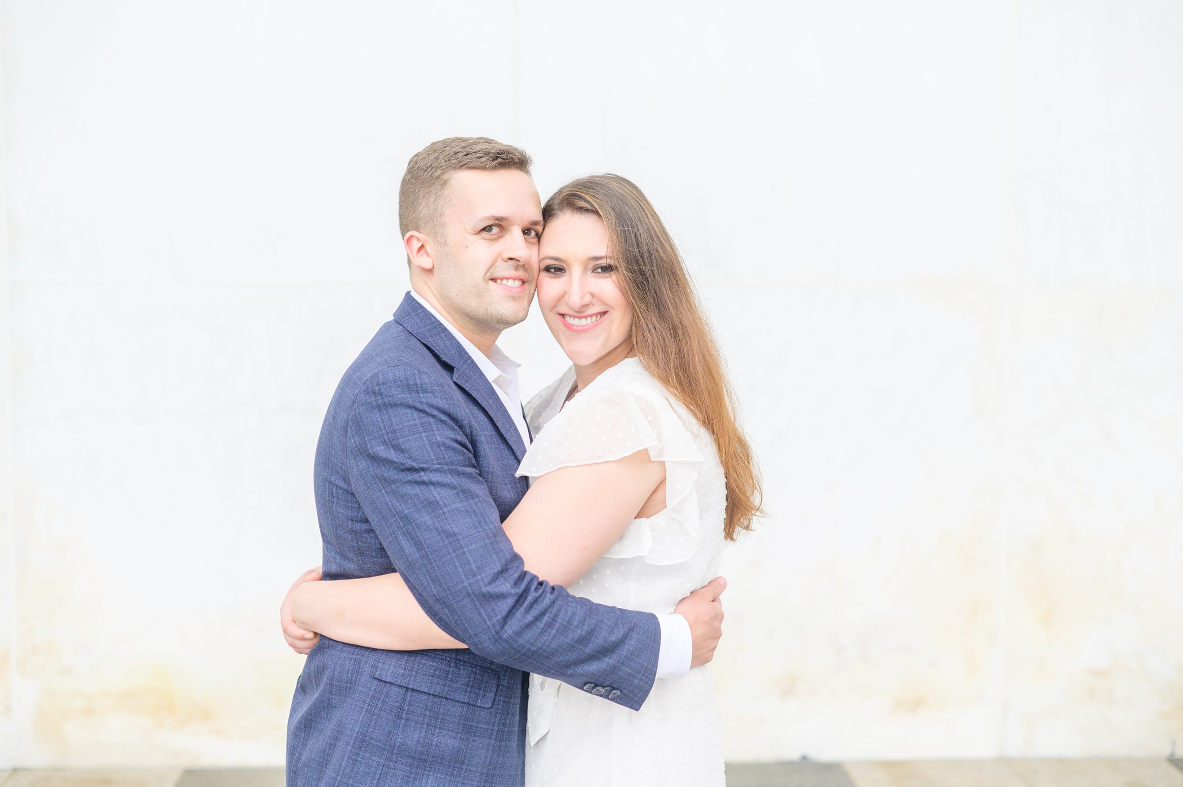 Engaged couple smiles near the Kennedy Center during engagement session at the Kennedy Center photographed by Baltimore Wedding Photographer Cait Kramer Photography