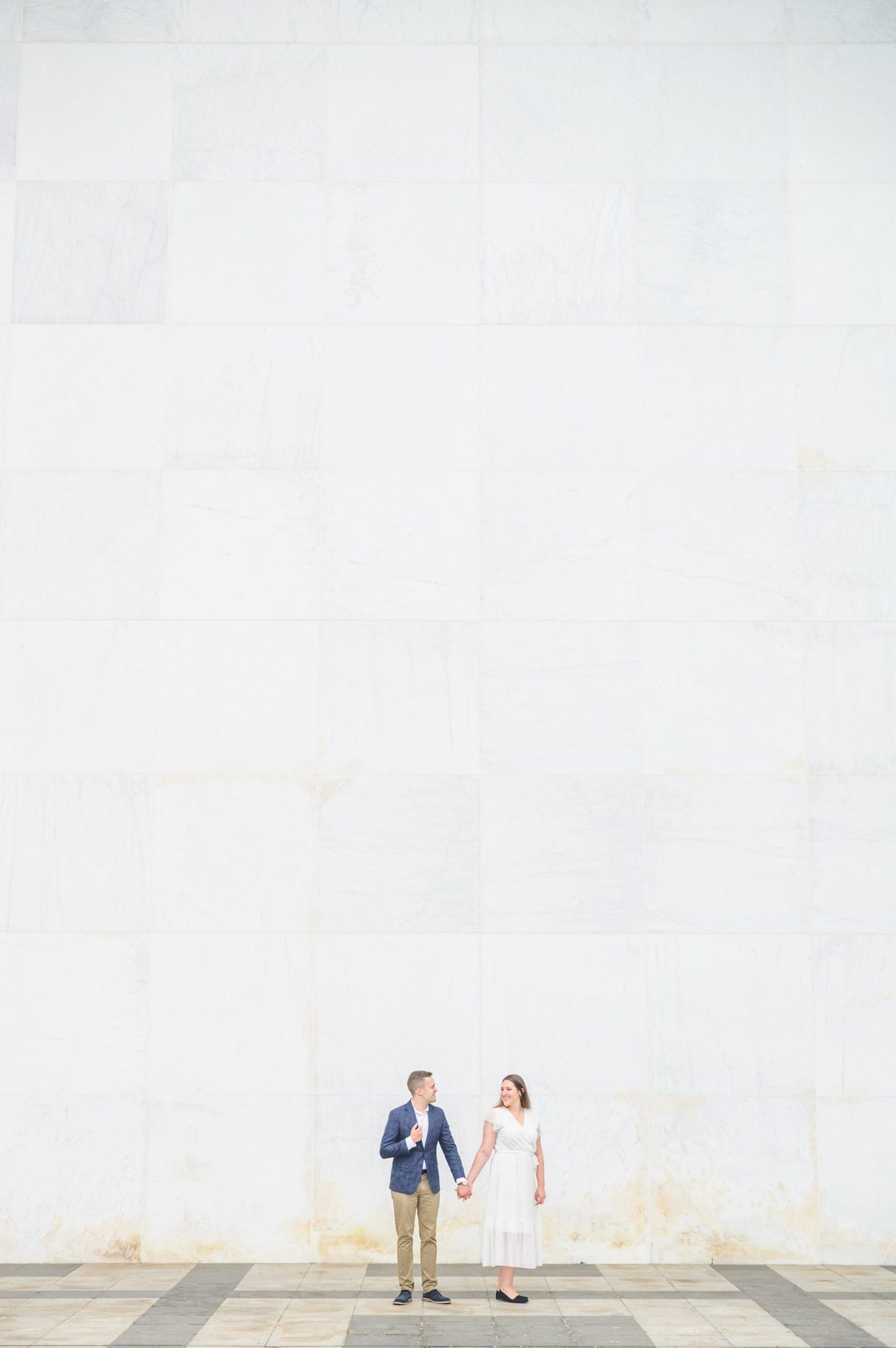 Engaged couple smiles near the Kennedy Center during engagement session at the Kennedy Center photographed by Baltimore Wedding Photographer Cait Kramer Photography