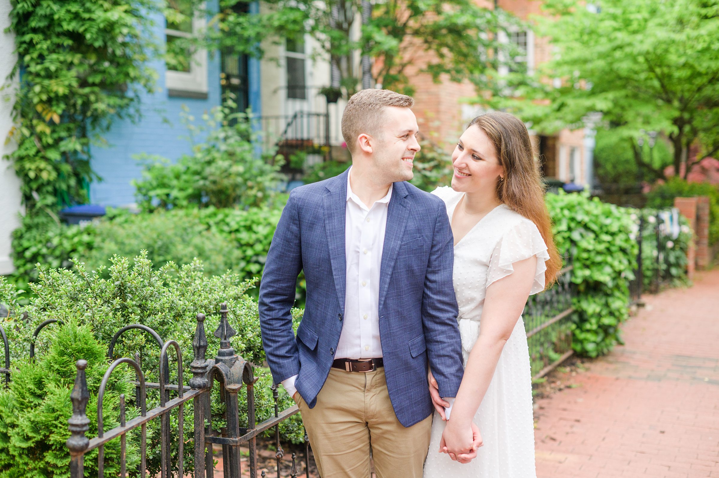Engaged couple smiles in Foggy Bottom during engagement session at the Kennedy Center photographed by Baltimore Wedding Photographer Cait Kramer Photography