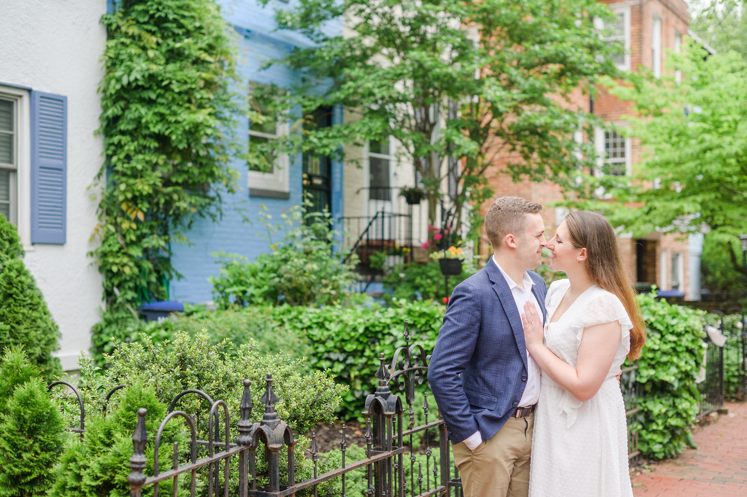 Engaged couple smiles in Foggy Bottom during engagement session at the Kennedy Center photographed by Baltimore Wedding Photographer Cait Kramer Photography