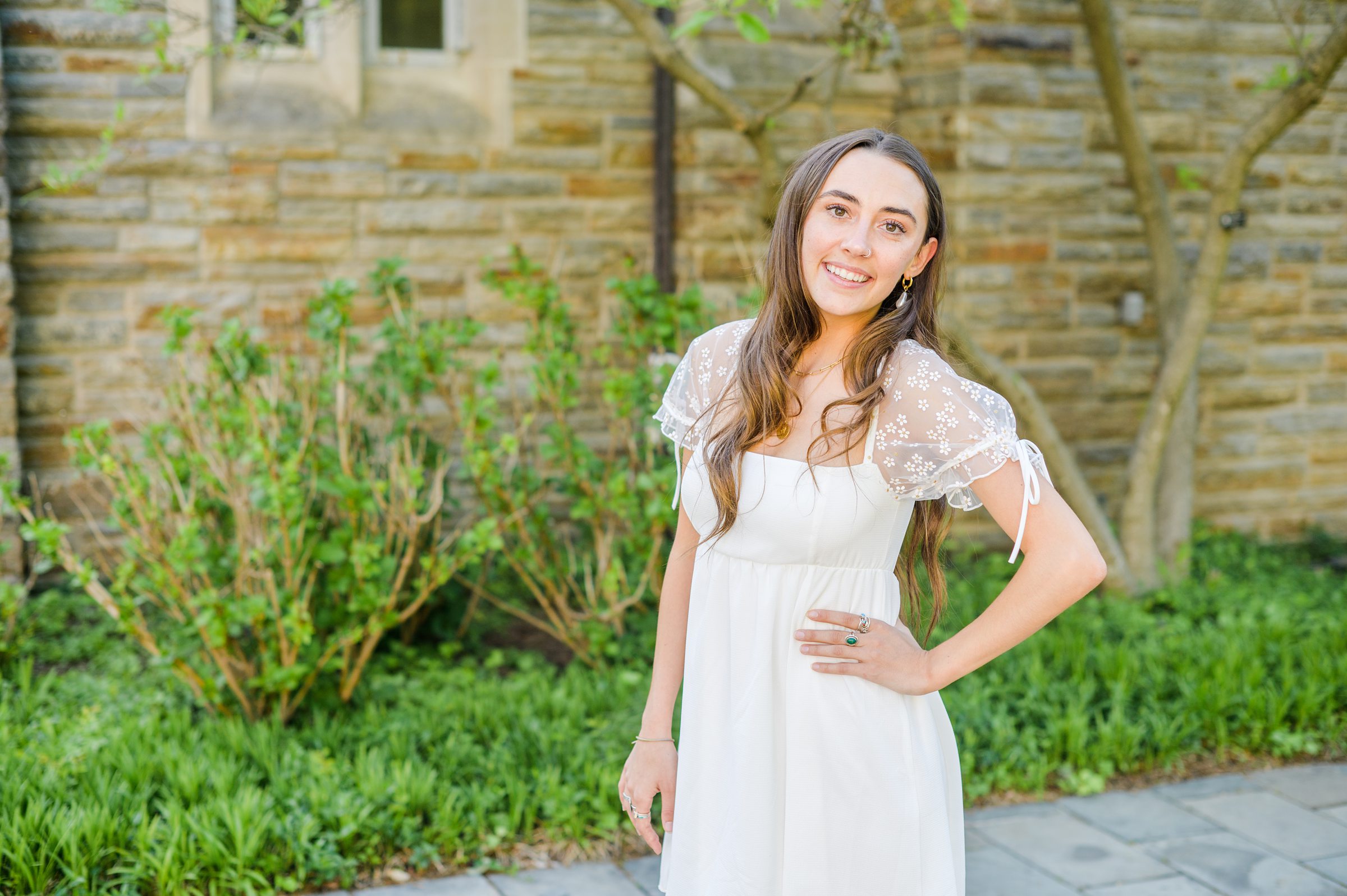 Loyola seniors pose on Loyola University Maryland's campus in graduation attire during Baltimore Grad Session photographed by Cait Kramer