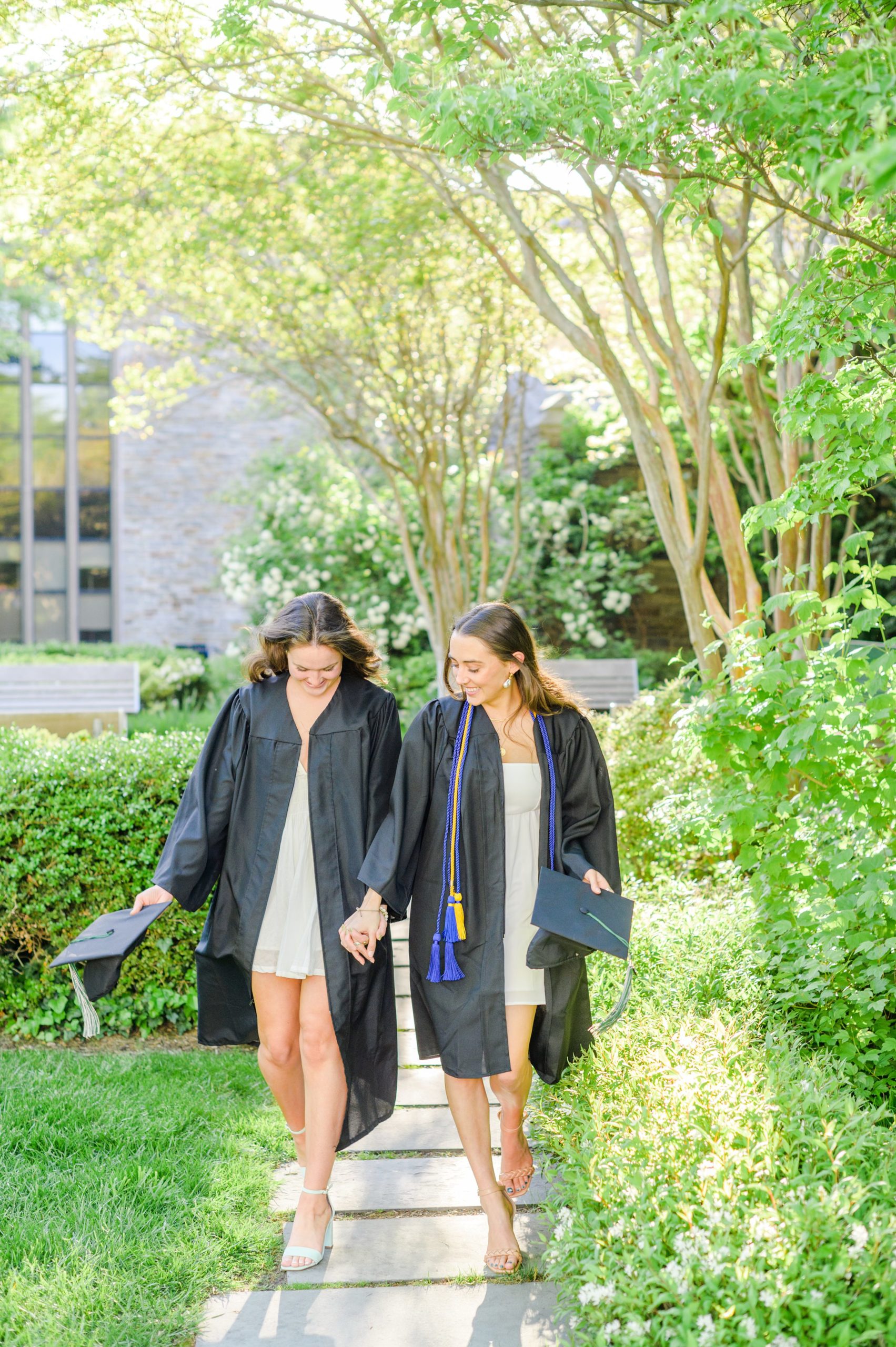 Loyola seniors pose on Loyola University Maryland's campus in graduation attire during Baltimore Grad Session photographed by Cait Kramer