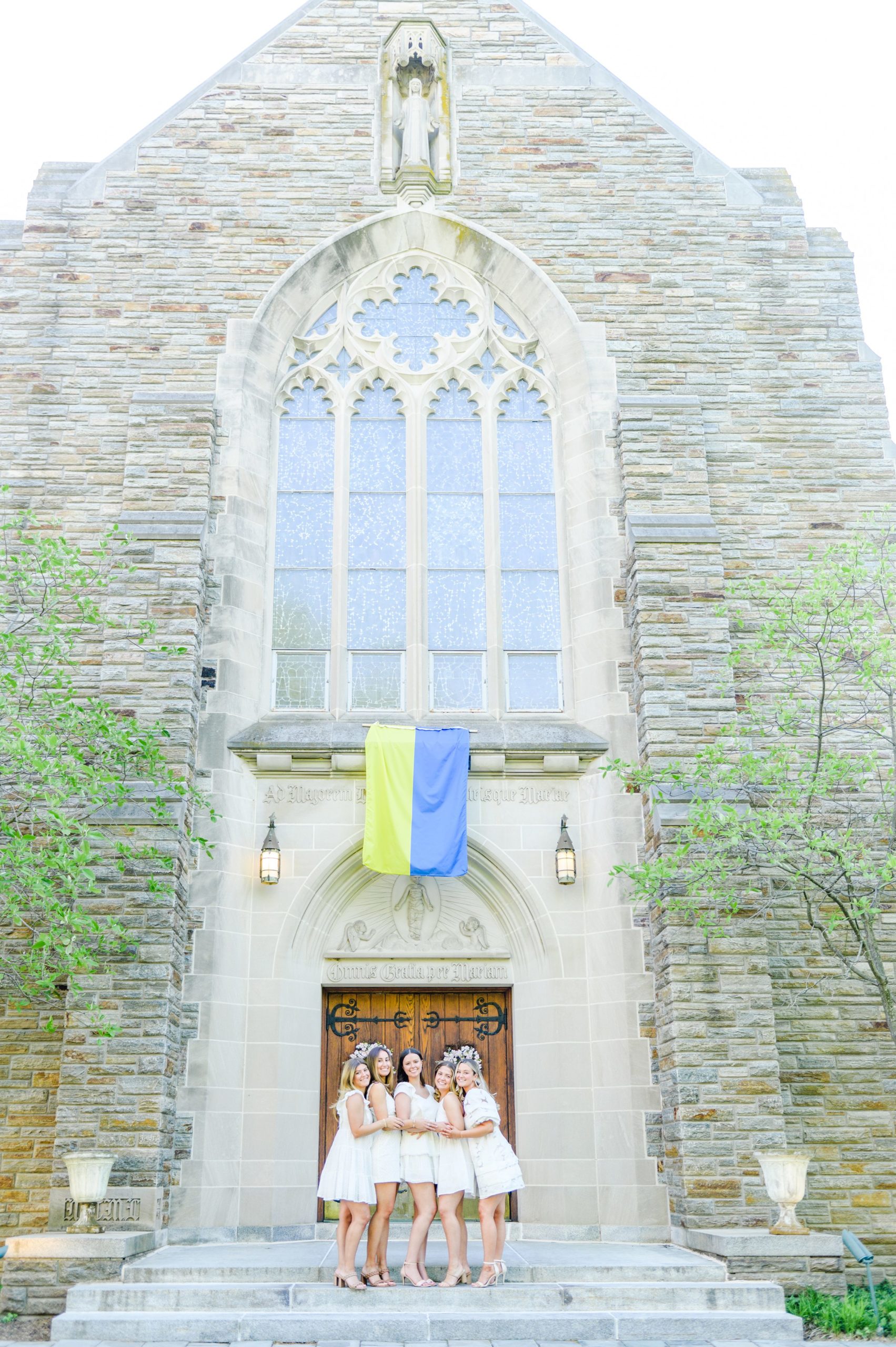 Loyola seniors pose on Loyola University Maryland's campus in graduation attire during Baltimore Grad Session photographed by Cait Kramer