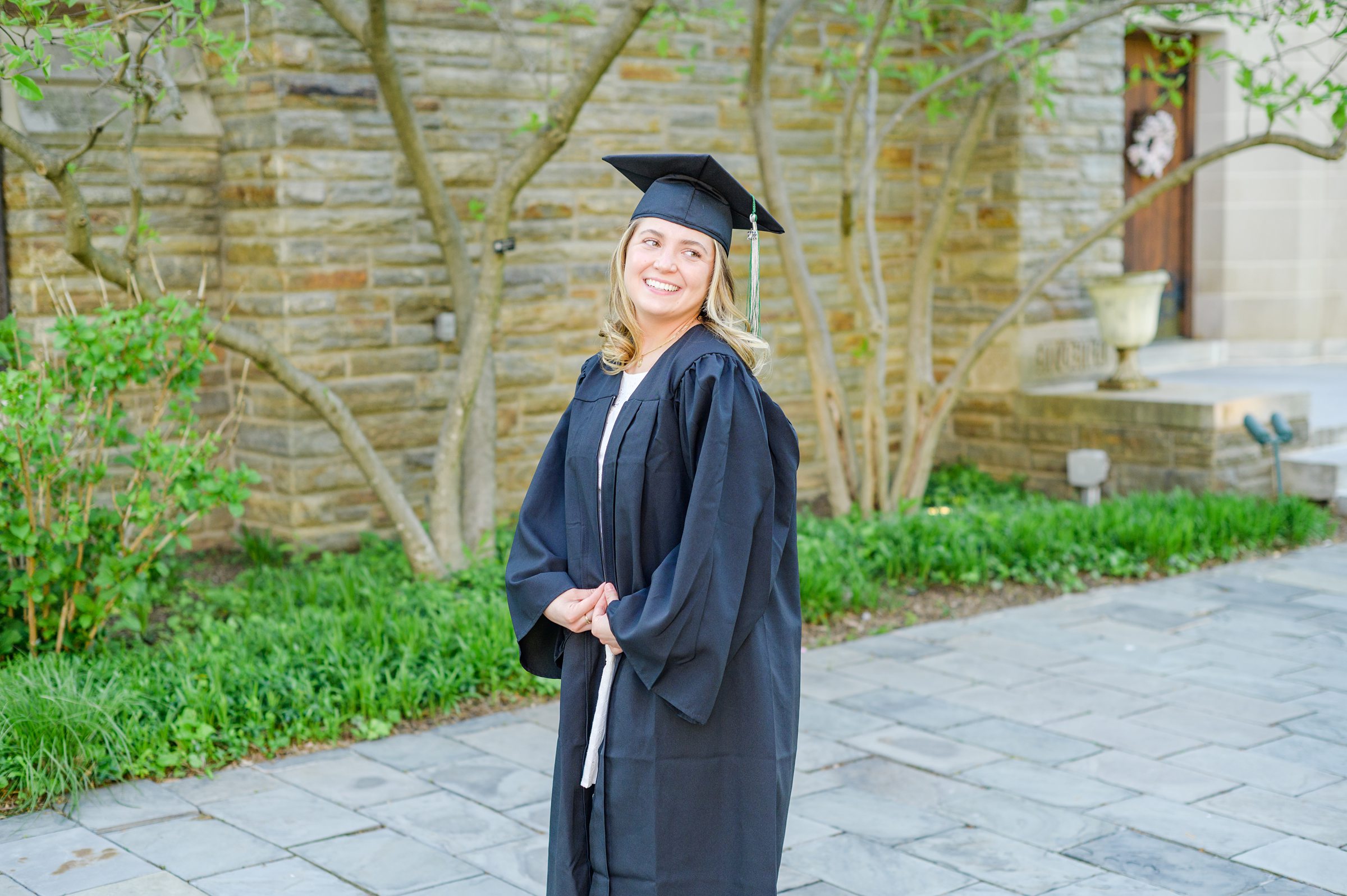 Loyola seniors pose on Loyola University Maryland's campus in graduation attire during Baltimore Grad Session photographed by Cait Kramer