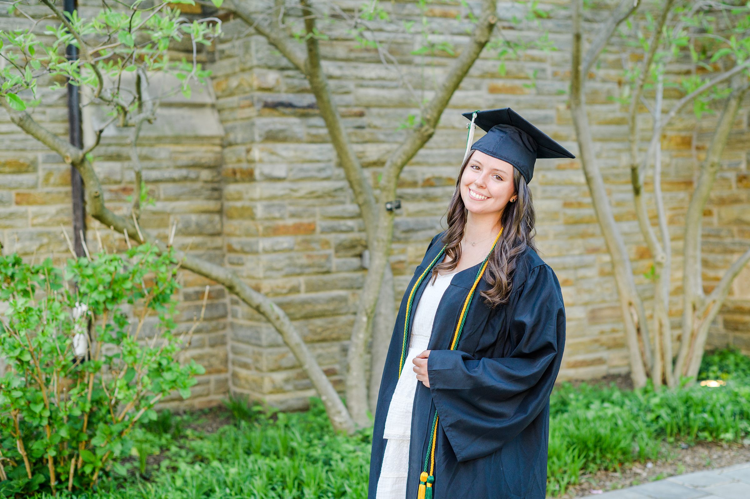 Loyola seniors pose on Loyola University Maryland's campus in graduation attire during Baltimore Grad Session photographed by Cait Kramer