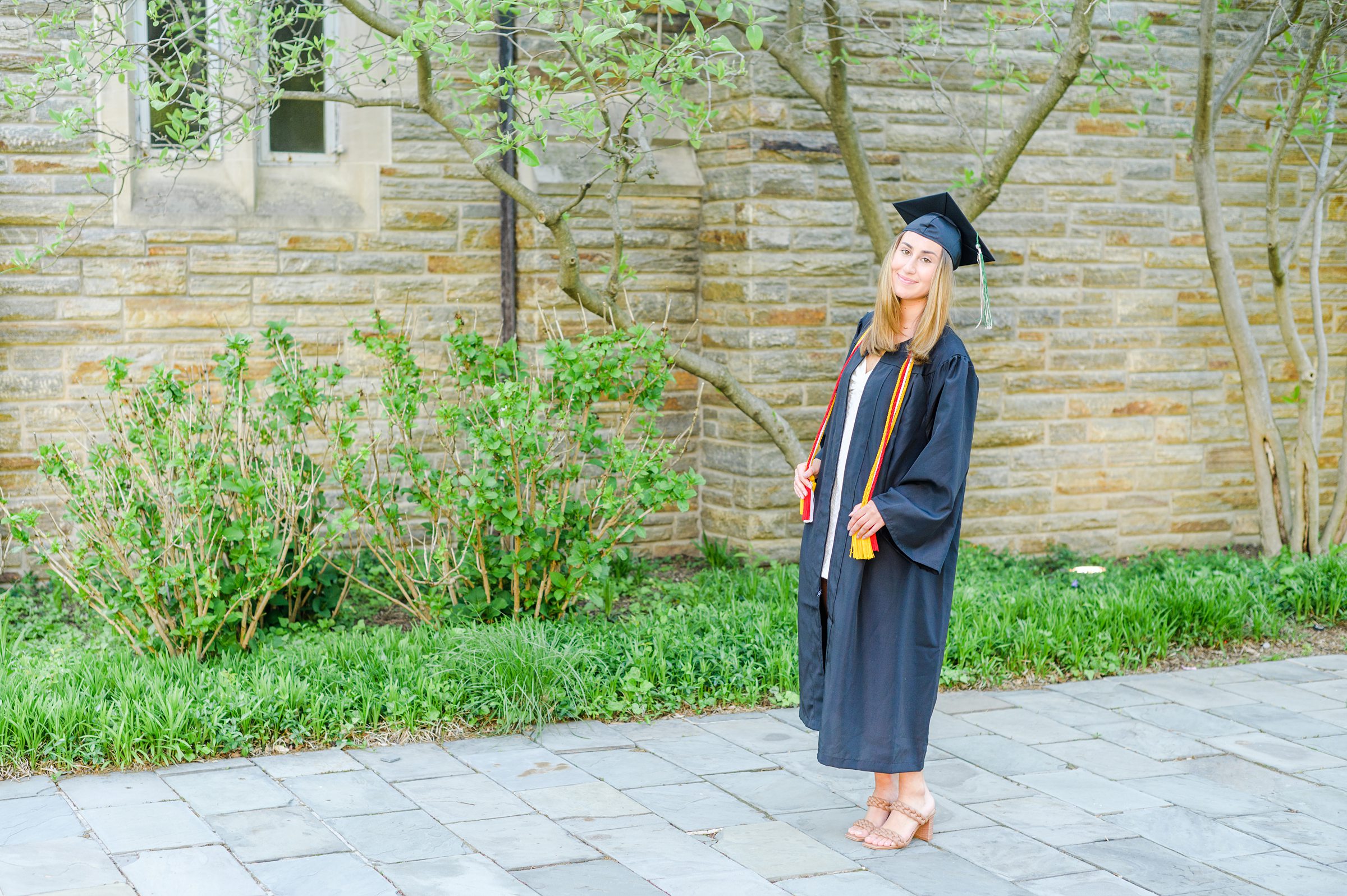 Loyola seniors pose on Loyola University Maryland's campus in graduation attire during Baltimore Grad Session photographed by Cait Kramer