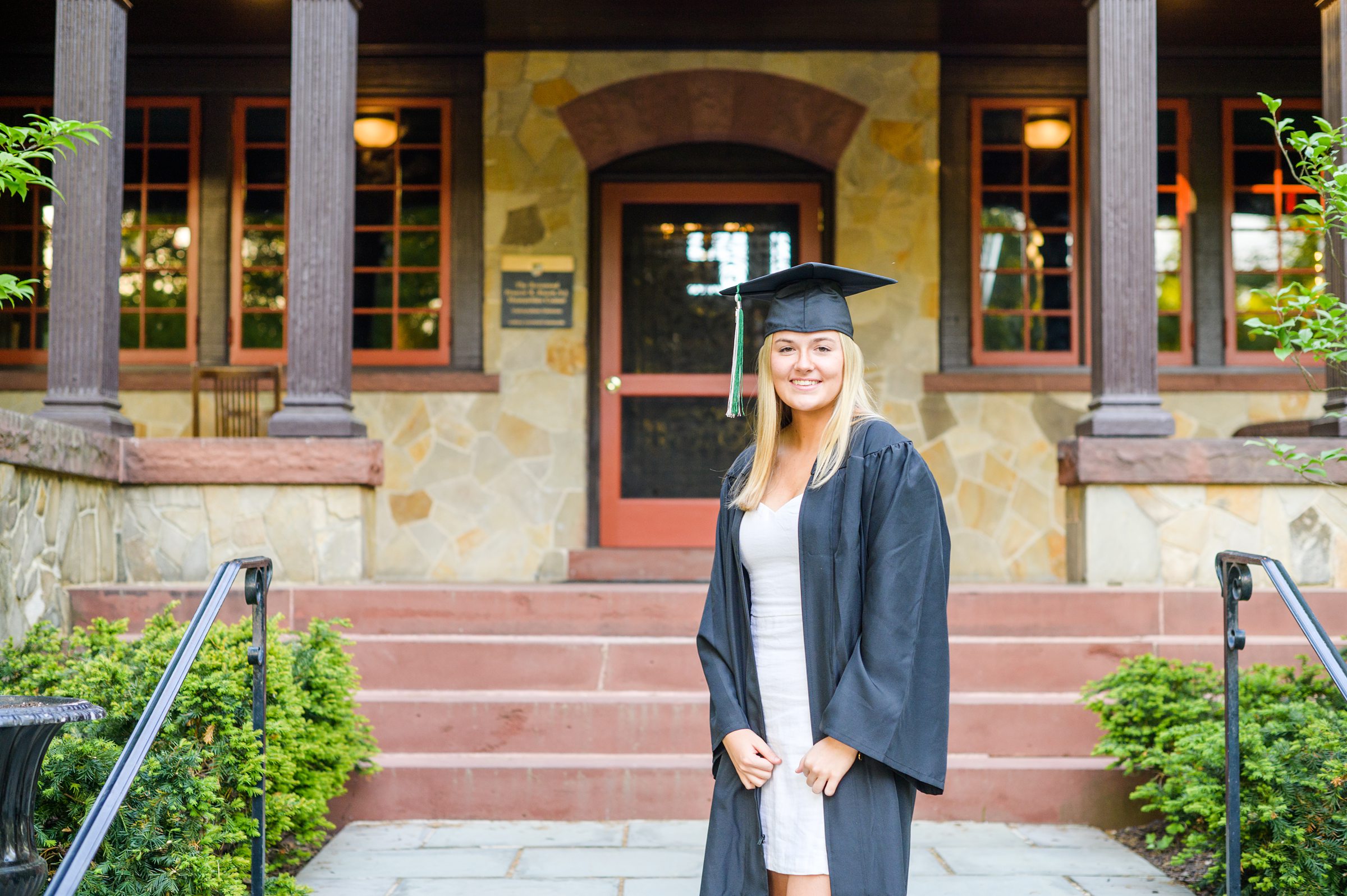 Loyola seniors pose on Loyola University Maryland's campus in graduation attire during Baltimore Grad Session photographed by Cait Kramer