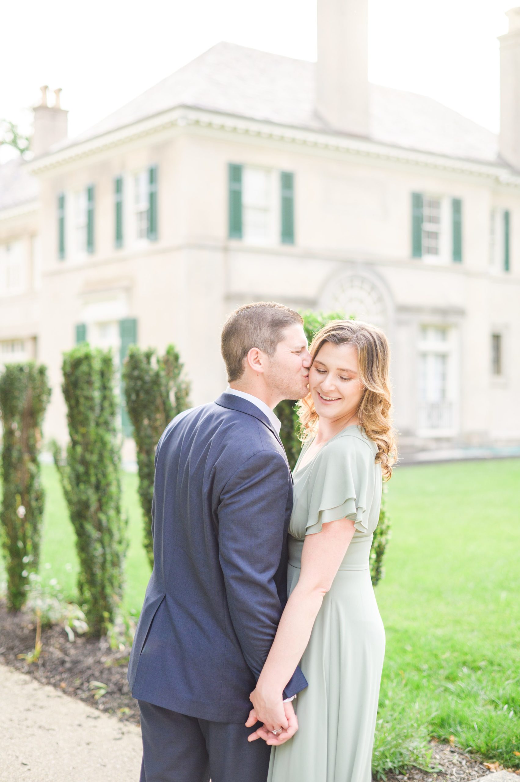 Engaged Couple smiles in Sherwood Gardens engagement session photographed by Maryland Wedding Photographer Cait Kramer Photography