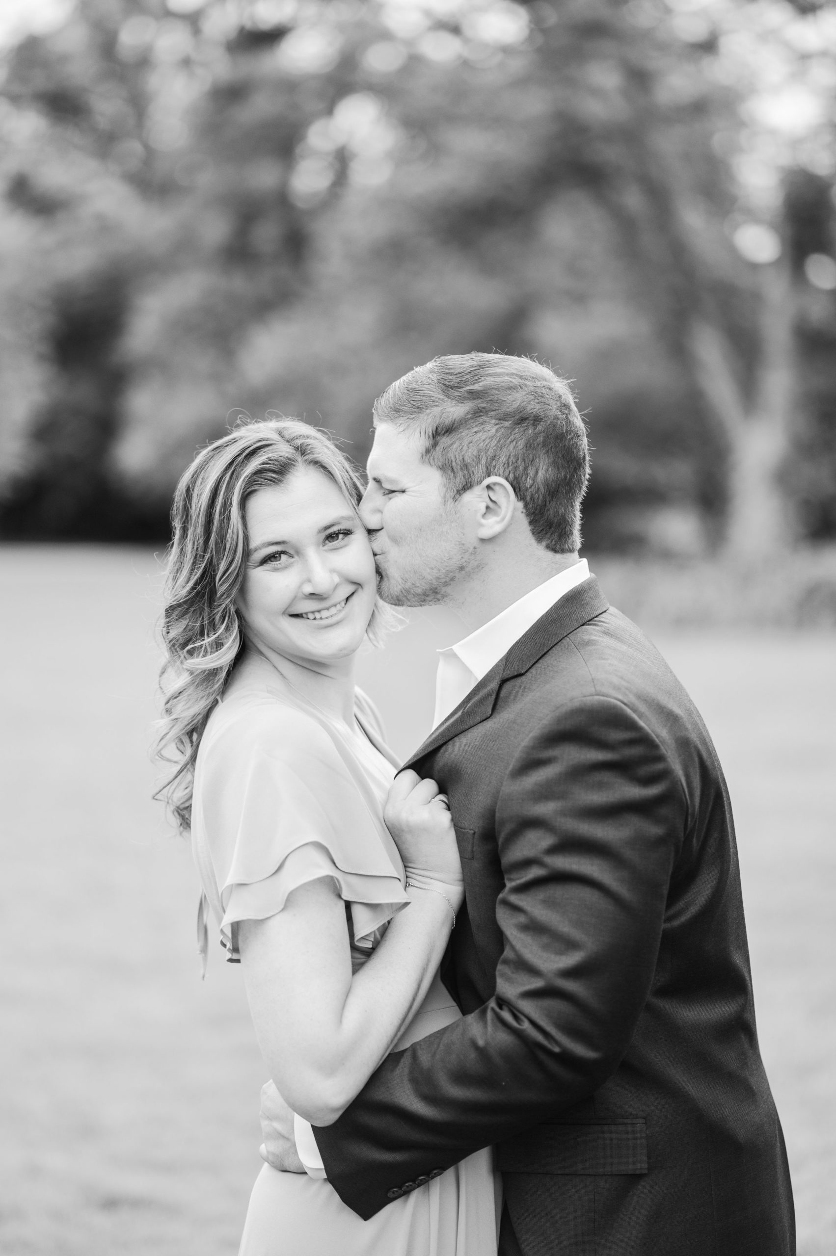 Engaged Couple smiles in Sherwood Gardens engagement session photographed by Maryland Wedding Photographer Cait Kramer Photography