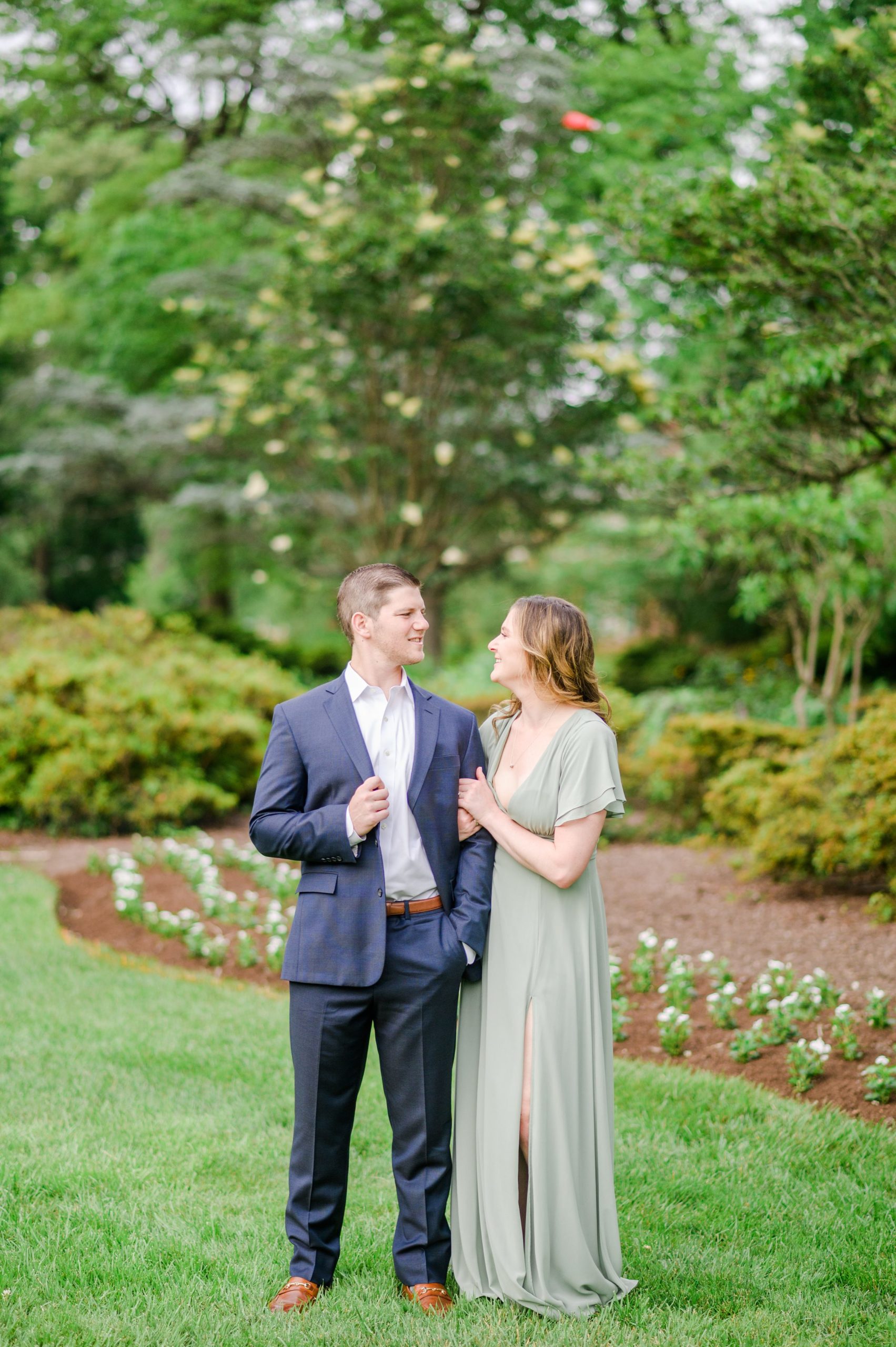 Engaged Couple smiles in Sherwood Gardens engagement session photographed by Maryland Wedding Photographer Cait Kramer Photography