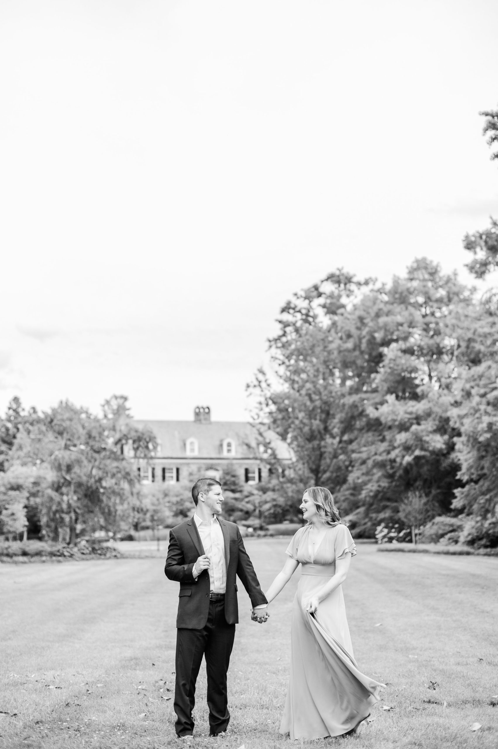 Engaged Couple smiles in Sherwood Gardens engagement session photographed by Maryland Wedding Photographer Cait Kramer Photography