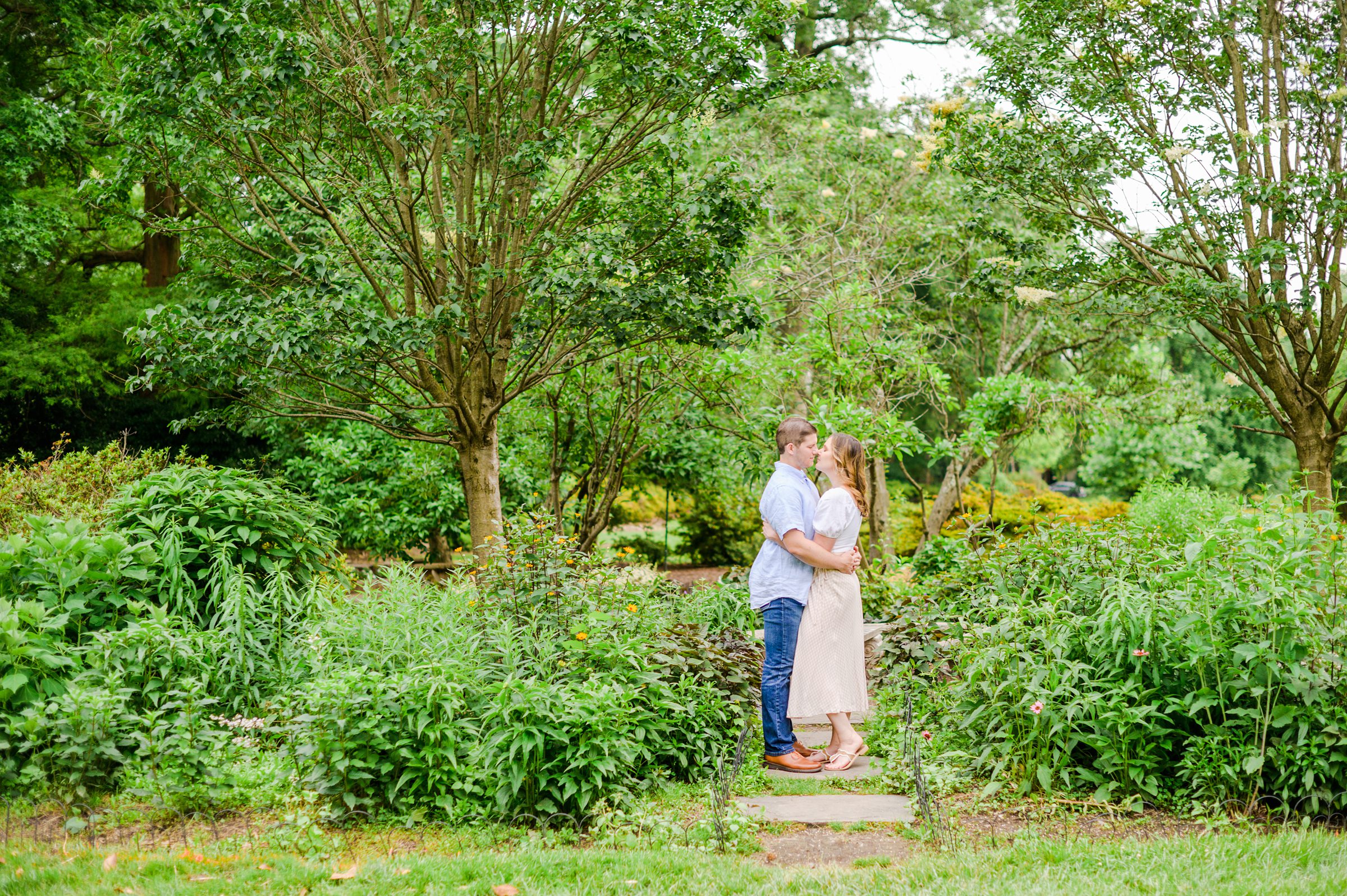 Engaged Couple smiles in Sherwood Gardens engagement session photographed by Maryland Wedding Photographer Cait Kramer Photography