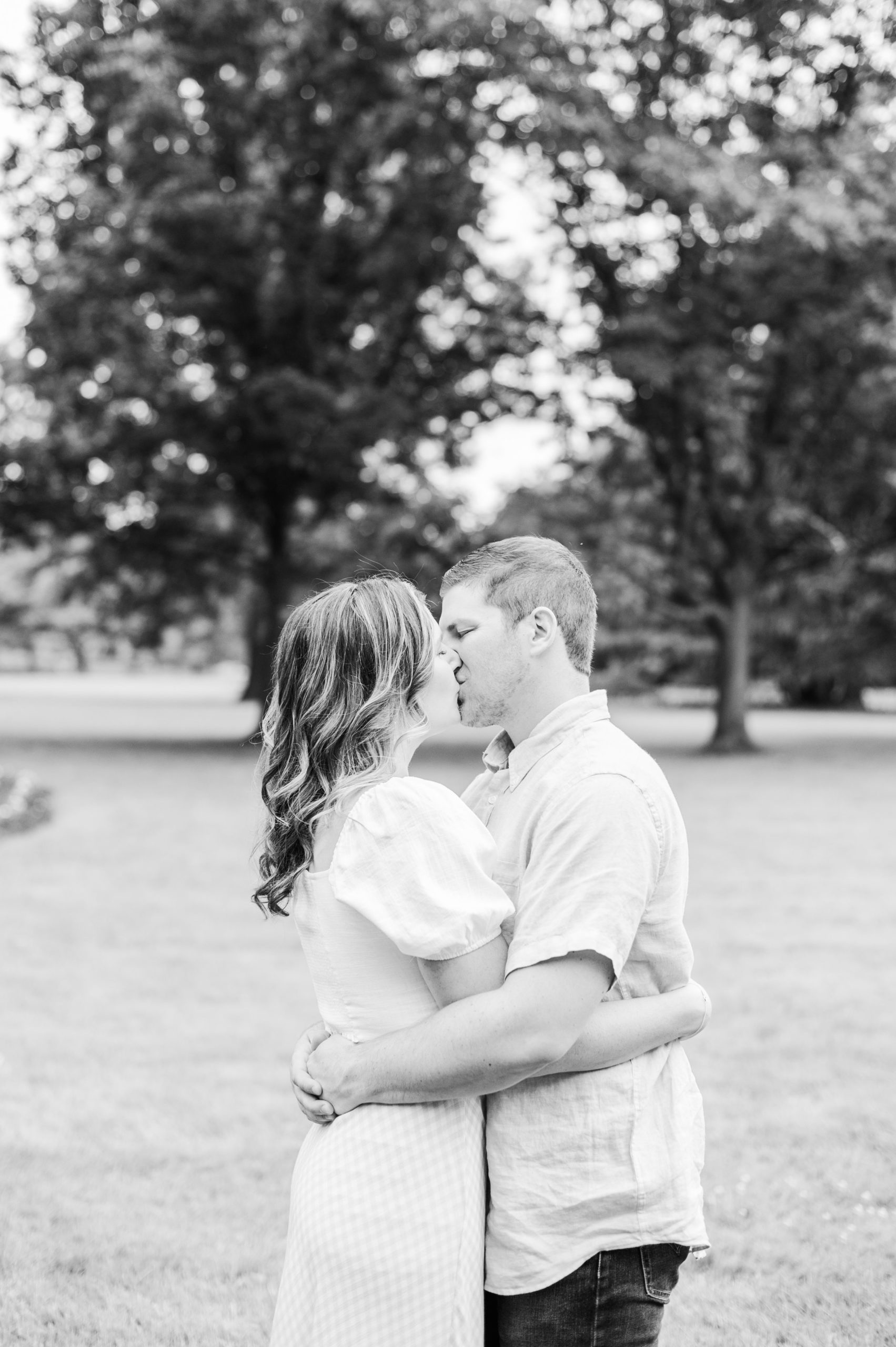 Engaged Couple smiles in Sherwood Gardens engagement session photographed by Maryland Wedding Photographer Cait Kramer Photography