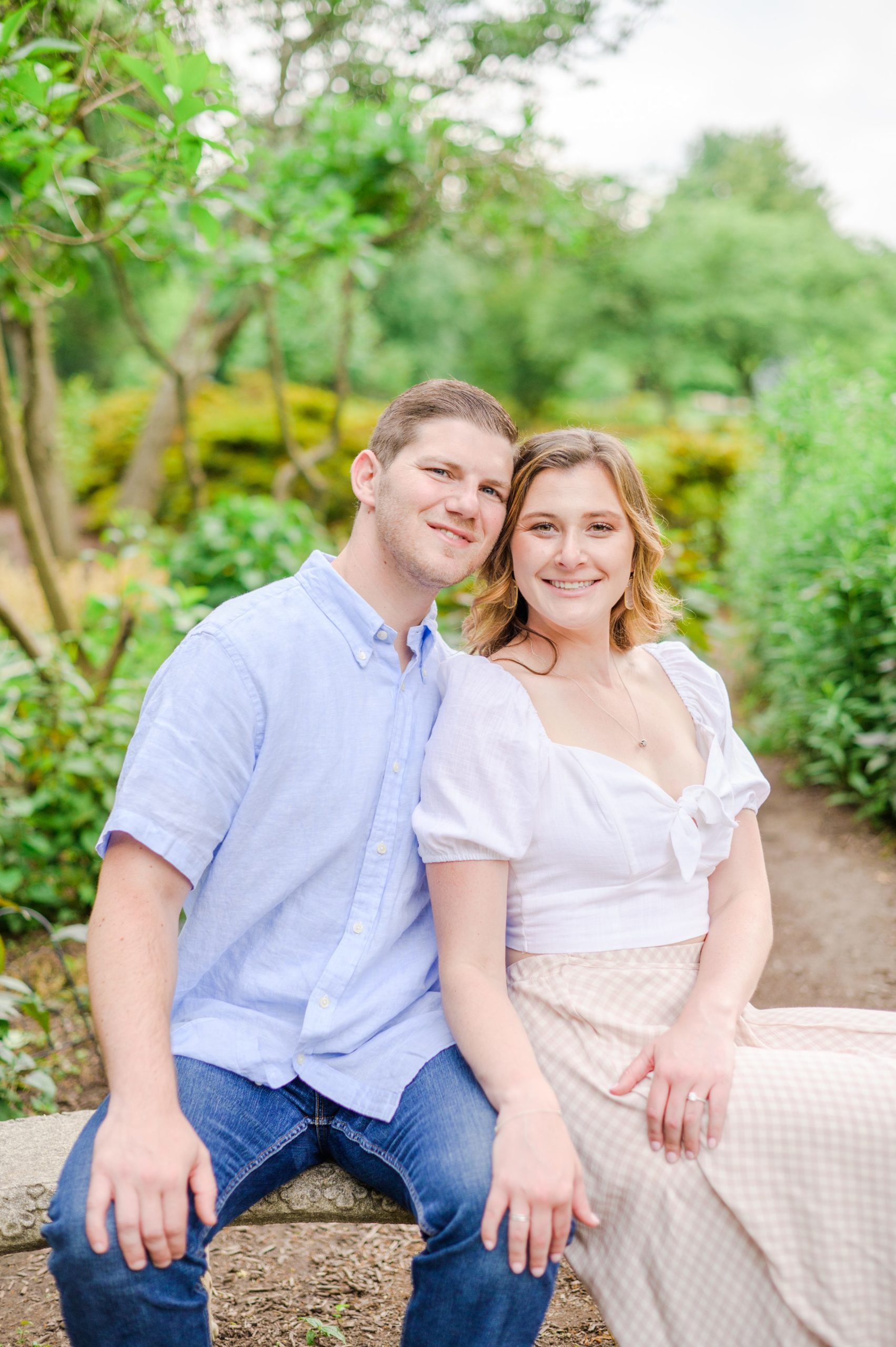 Engaged Couple smiles in Sherwood Gardens engagement session photographed by Maryland Wedding Photographer Cait Kramer Photography