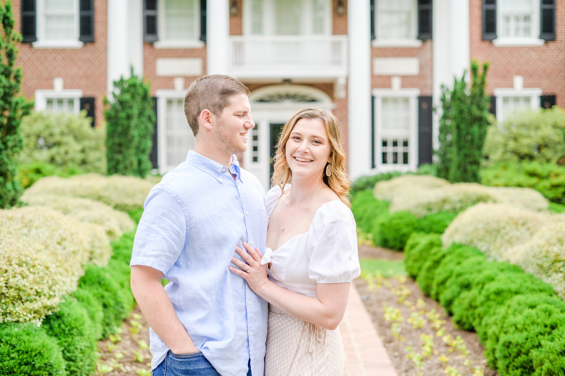 Engaged Couple smiles in Sherwood Gardens engagement session photographed by Maryland Wedding Photographer Cait Kramer Photography