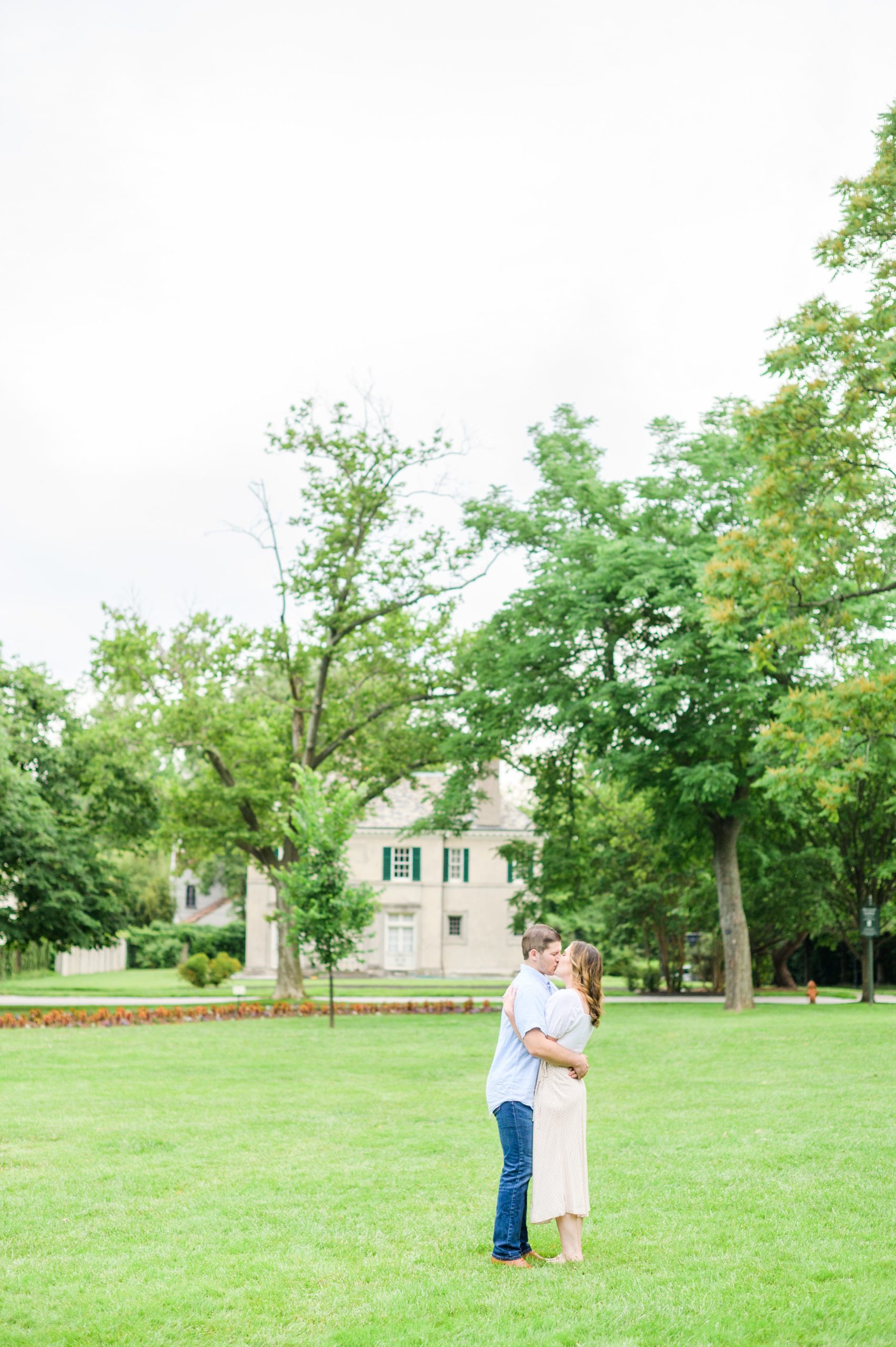 Engaged Couple smiles in Sherwood Gardens engagement session photographed by Maryland Wedding Photographer Cait Kramer Photography