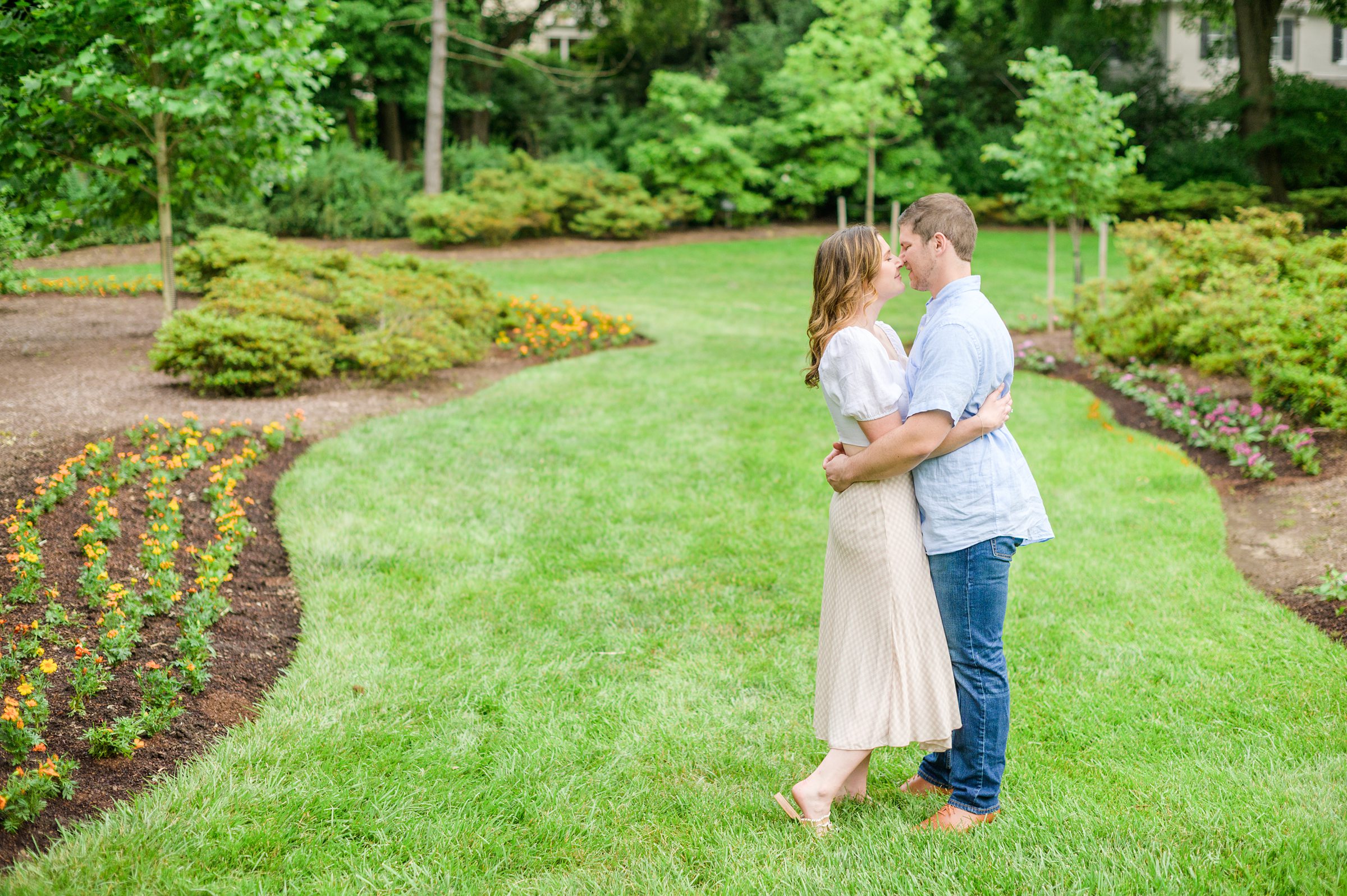 Engaged Couple smiles in Sherwood Gardens engagement session photographed by Maryland Wedding Photographer Cait Kramer Photography