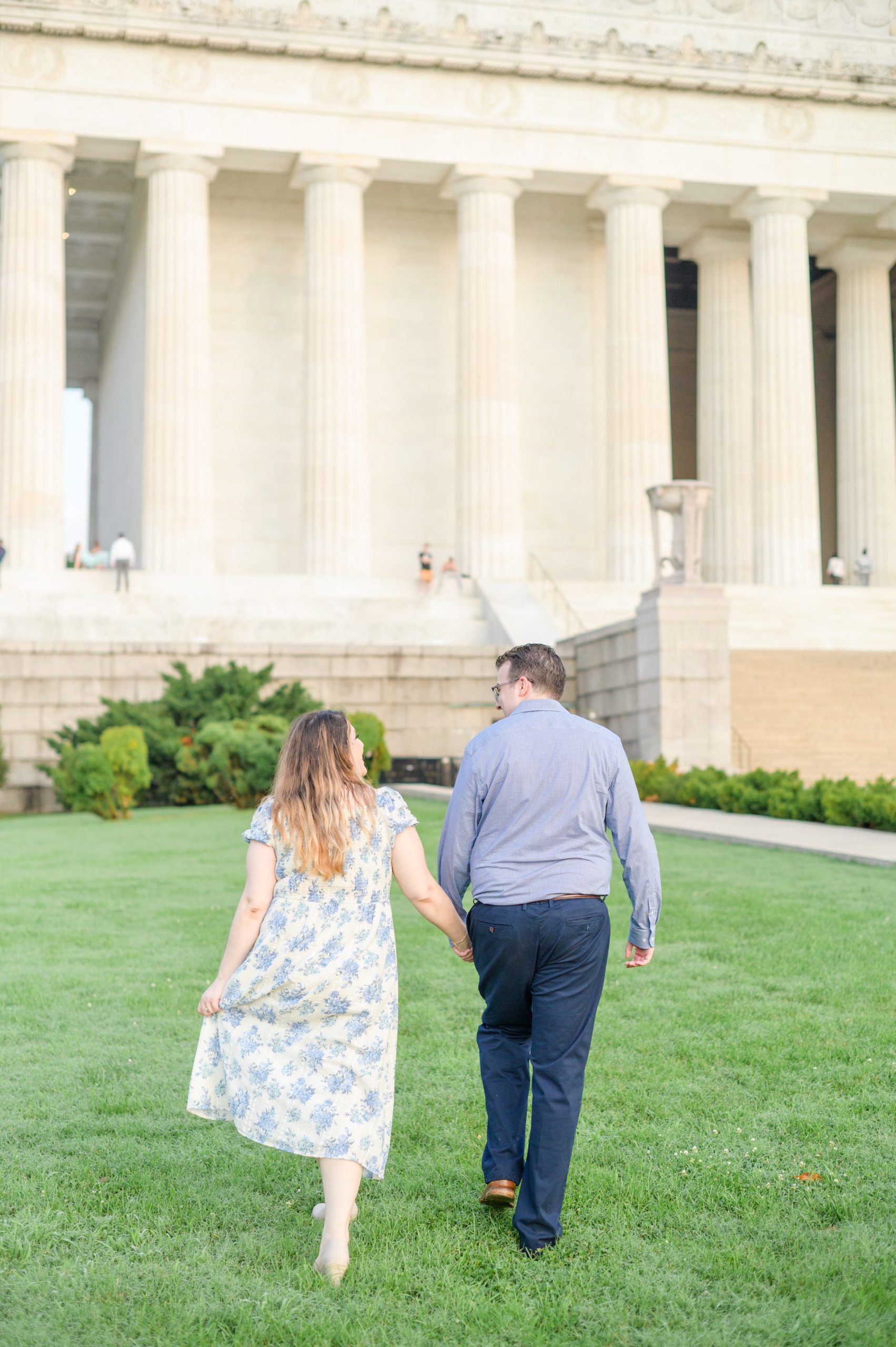 Couple smiles during their engagement photos at the Lincoln Memorial photographed by Baltimore Wedding Photographer, Cait Kramer Photography