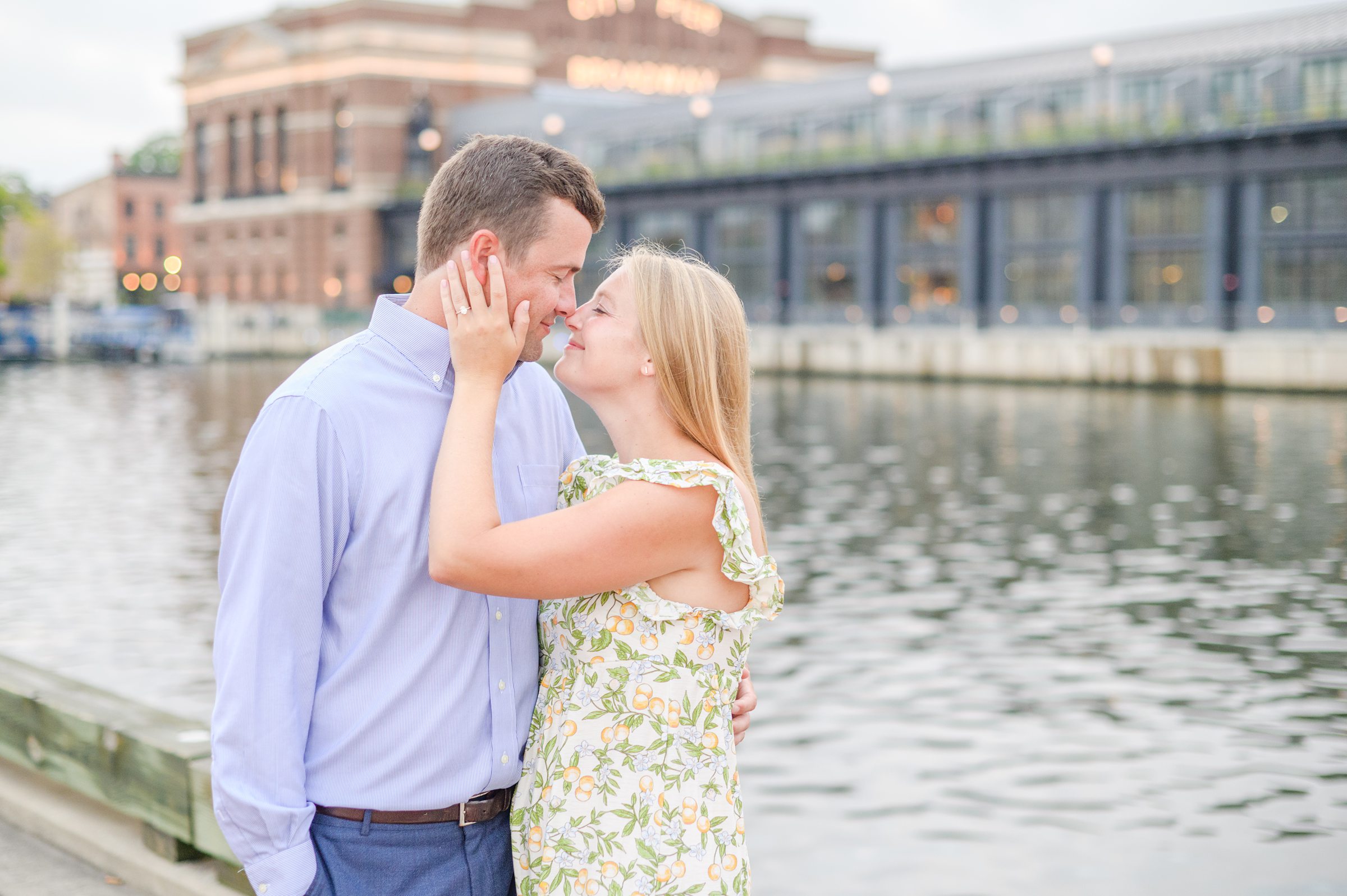 Couple poses on Broadway pier during Fells Point engagement session photographed by Baltimore wedding photographer Cait Kramer