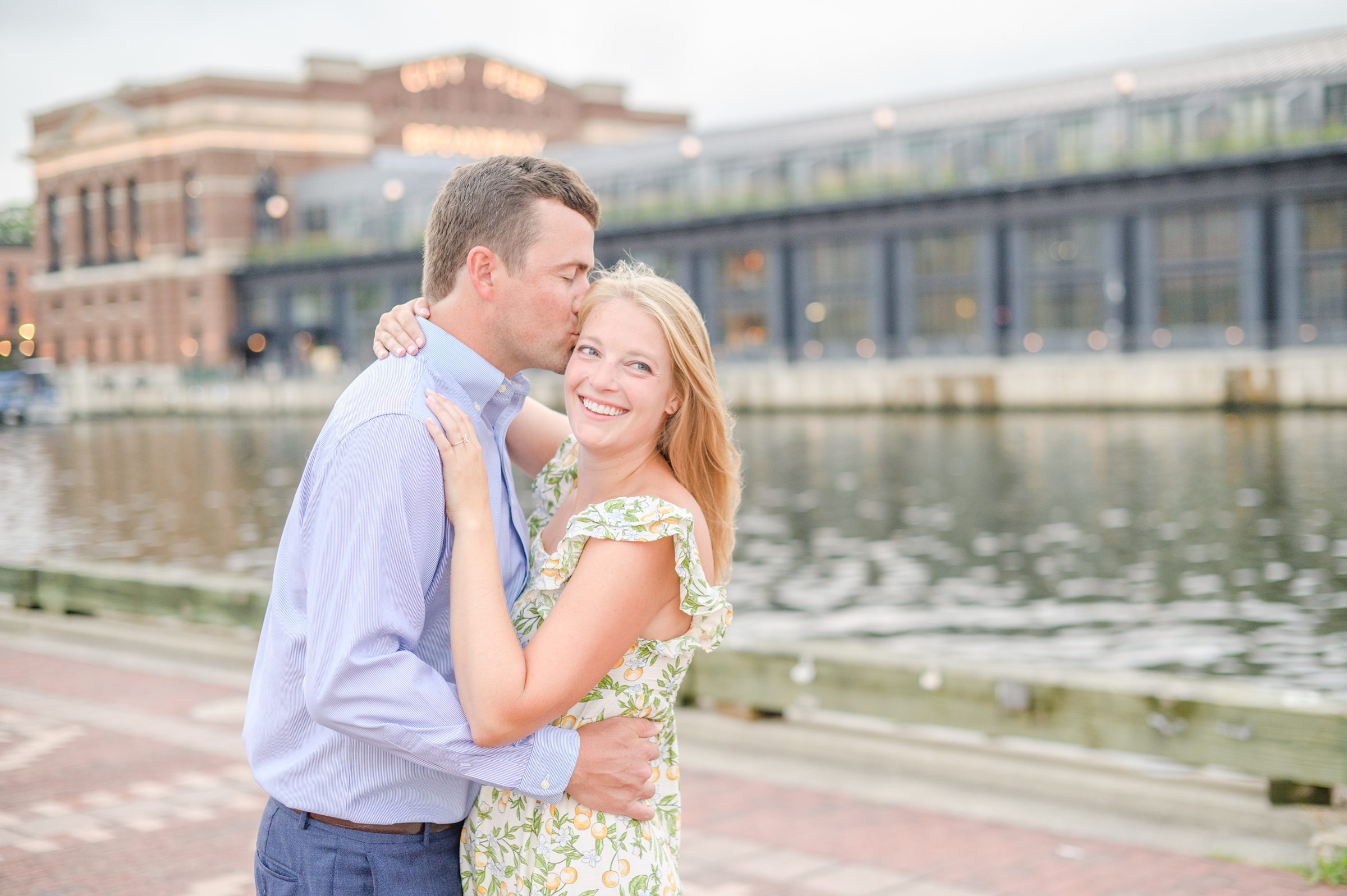 Couple poses on Broadway pier during Fells Point engagement session photographed by Baltimore wedding photographer Cait Kramer