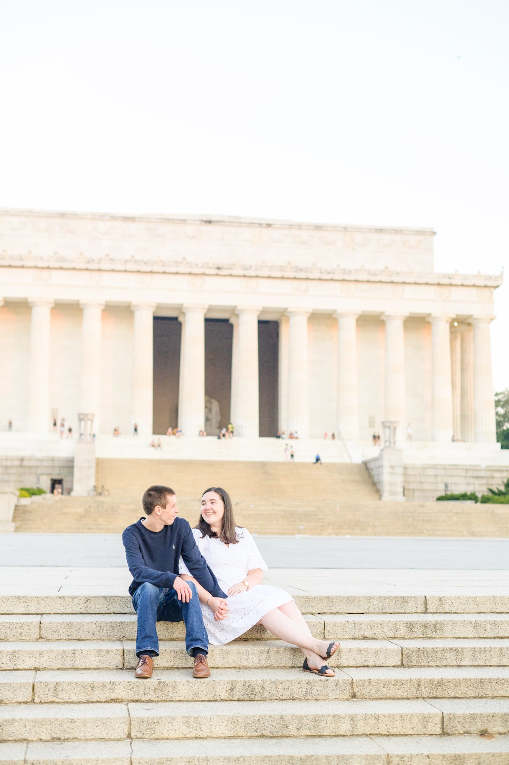 Couple smiles during their Lincoln Memorial engagement photos during session photographed by Baltimore wedding photographer, Cait Kramer