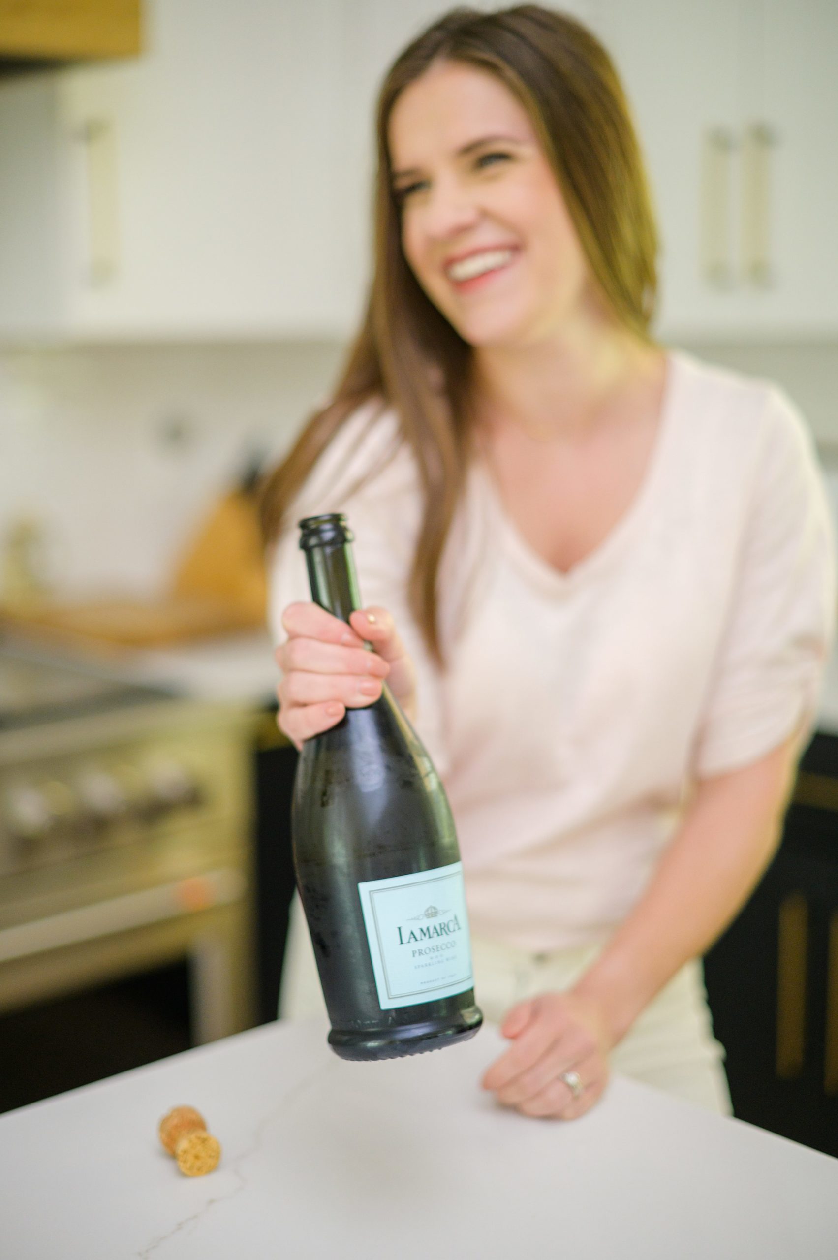 Stacey Caito, Chantilly Realtor, toasts champagne during her brand session photographed by Virginia brand photographer, Cait Kramer Photography