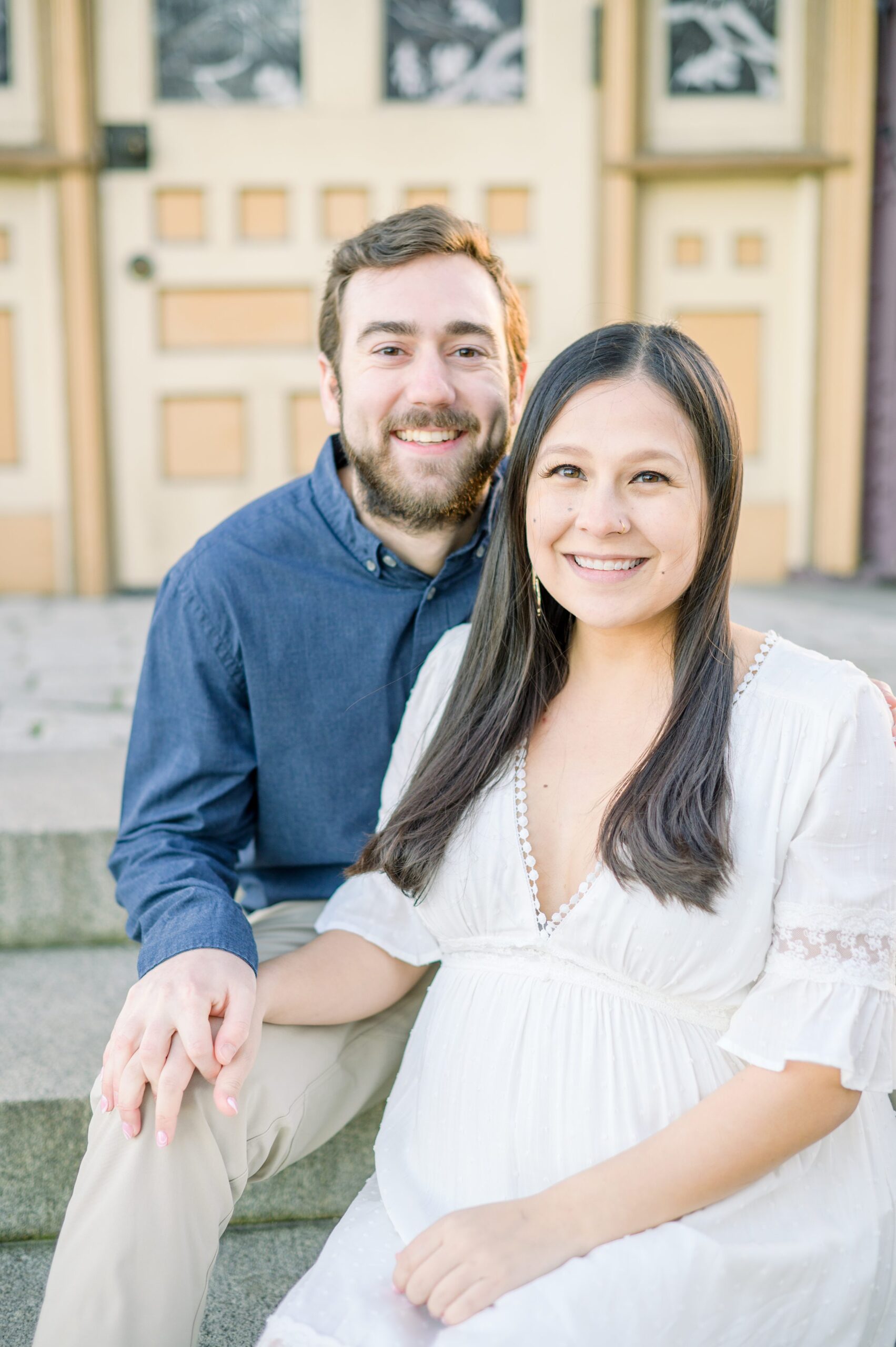 Abby and Nick's maternity session in Patterson Park in Baltimore County featuring a stunning golden hour and beautiful pink trees.