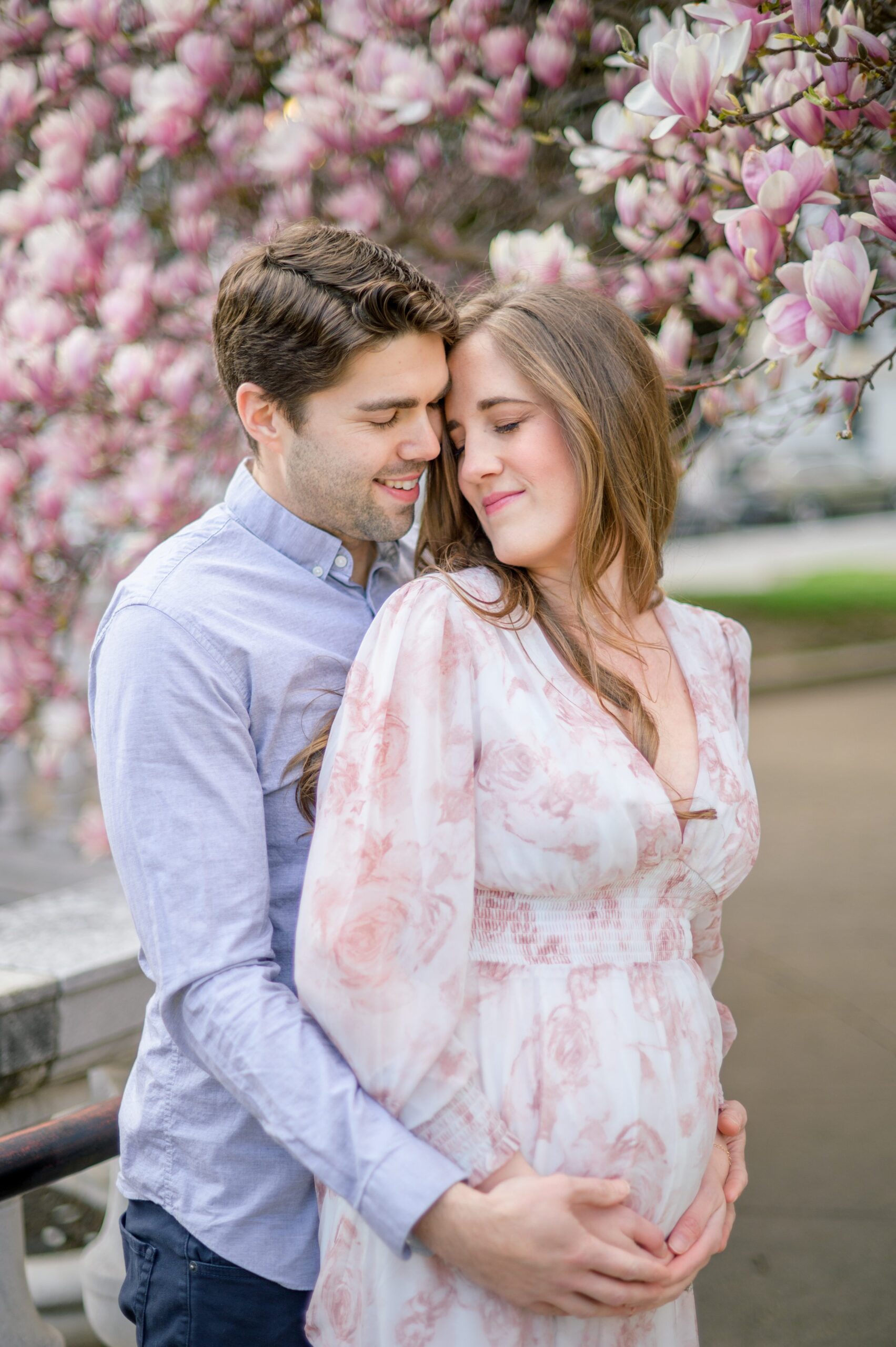 Meg and Sean's maternity photos in Baltimore featuring stunning pink magnolia trees by Baltimore Photographer Cait Kramer Photography