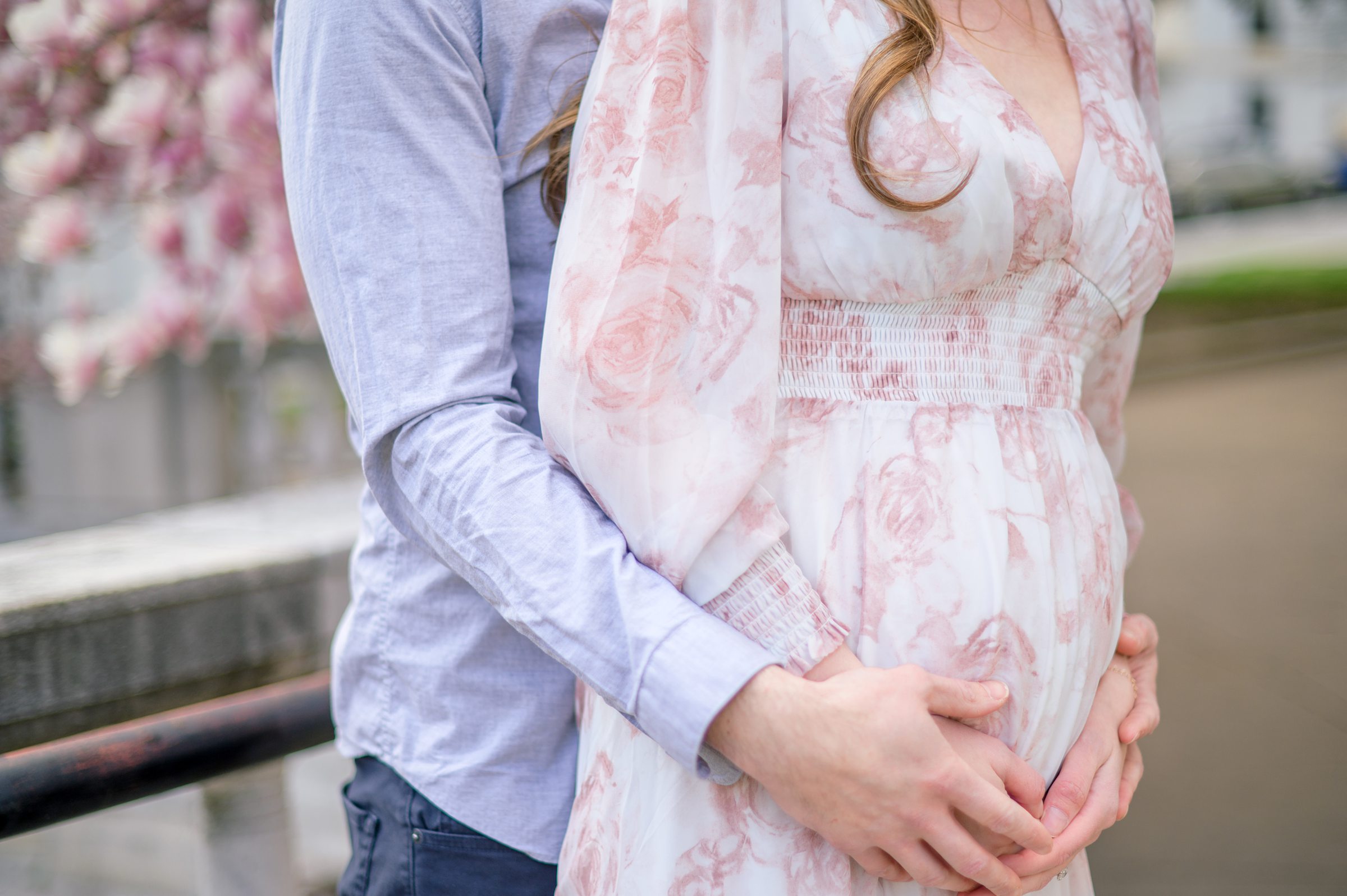 Meg and Sean's maternity photos in Baltimore featuring stunning pink magnolia trees by Baltimore Photographer Cait Kramer Photography