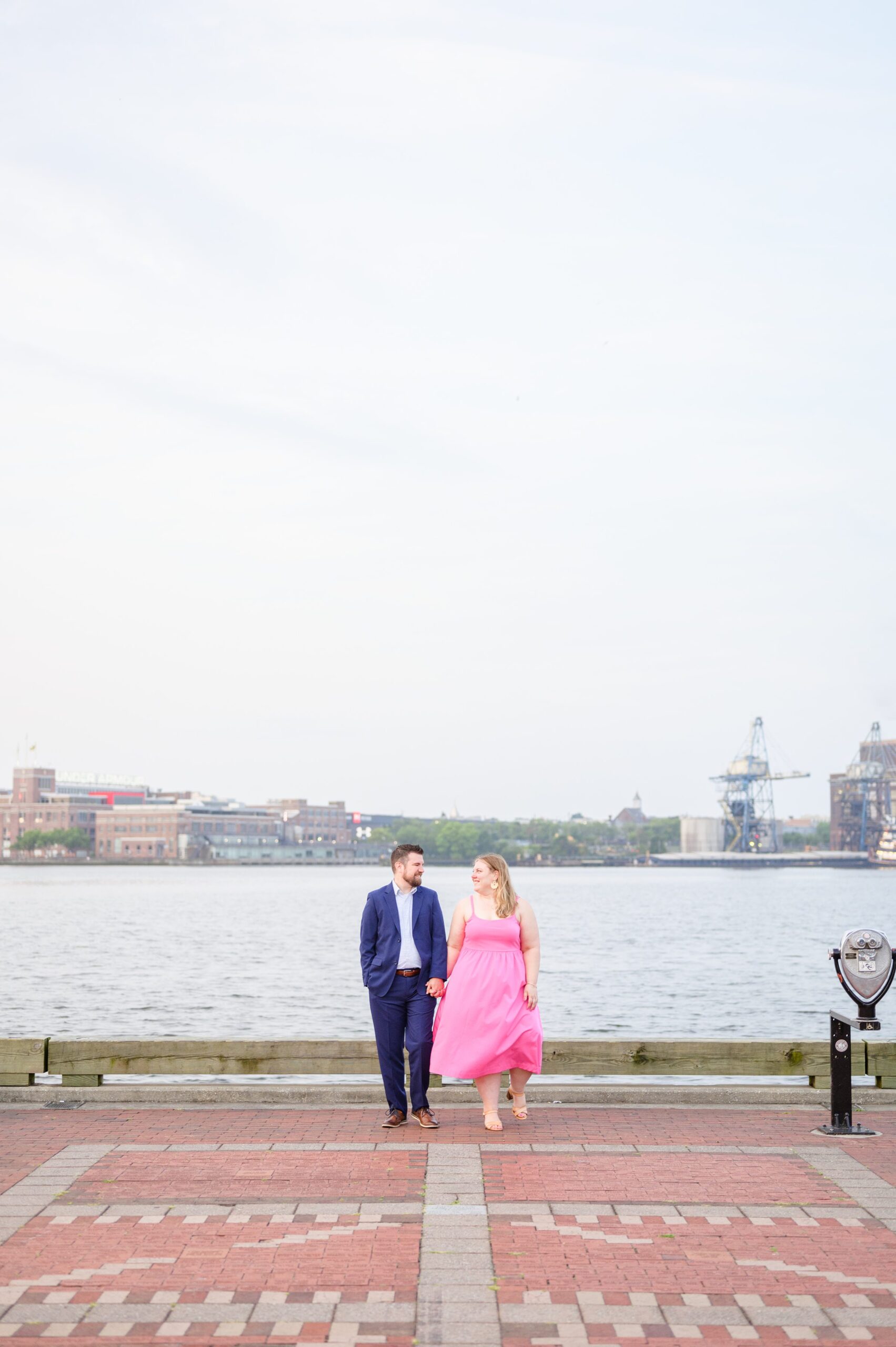 Engaged couple at Fells Point Waterfront for their sunrise engagement session in Baltimore, Maryland photographed by Baltimore Wedding Photographer Cait Kramer Photography.