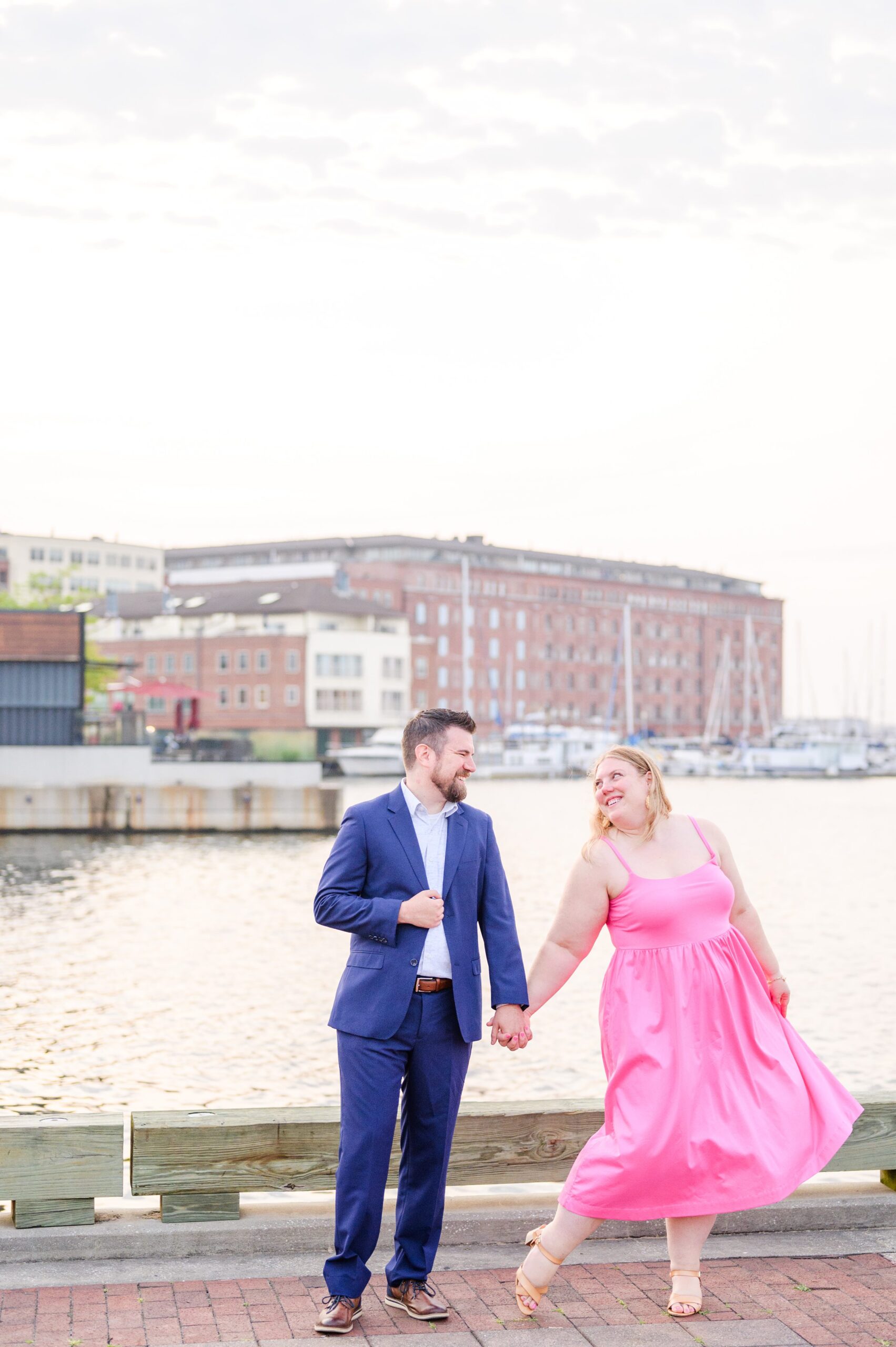 Engaged couple at Fells Point Waterfront for their sunrise engagement session in Baltimore, Maryland photographed by Baltimore Wedding Photographer Cait Kramer Photography.