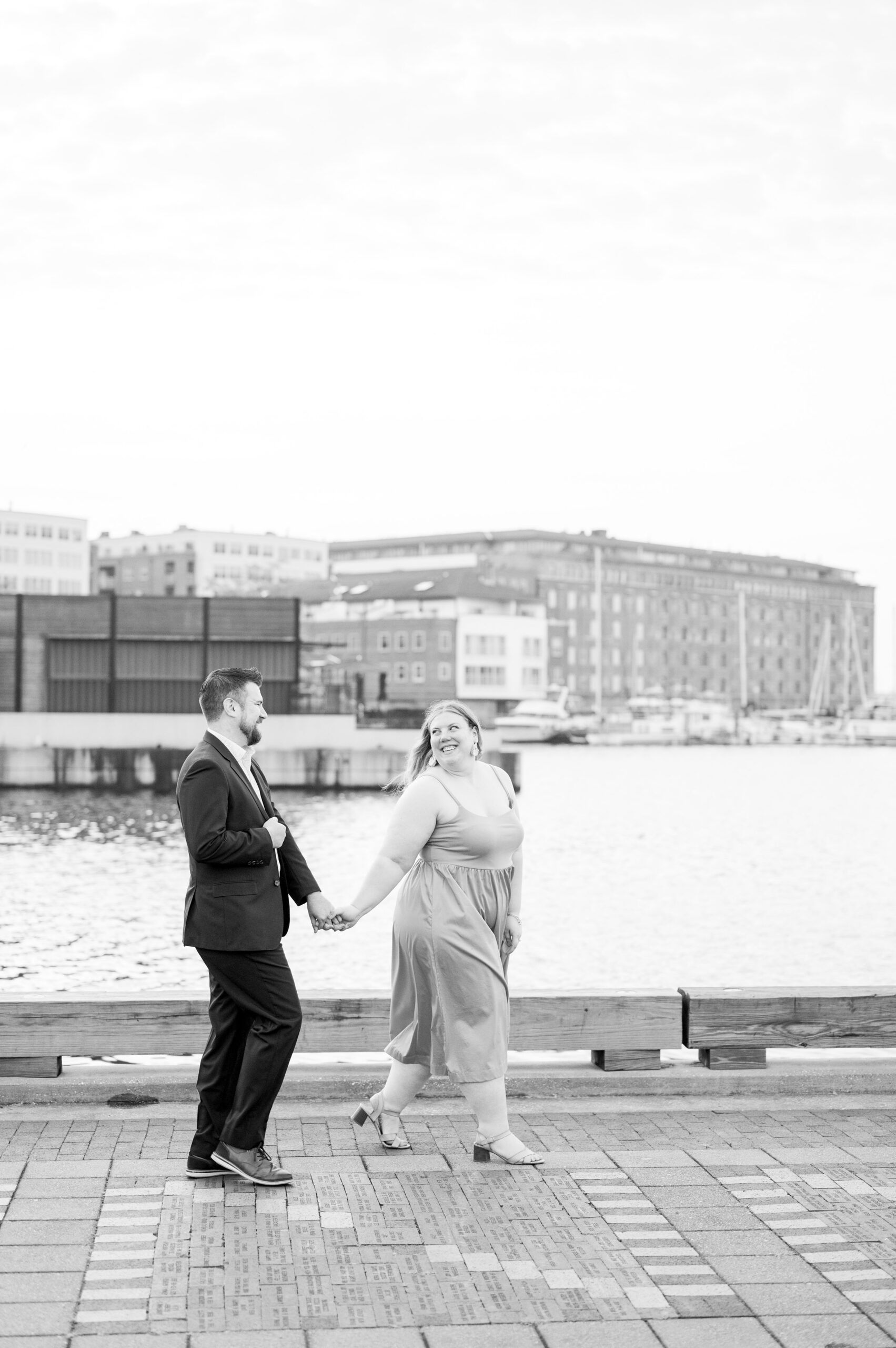 Engaged couple at Fells Point Waterfront for their sunrise engagement session in Baltimore, Maryland photographed by Baltimore Wedding Photographer Cait Kramer Photography.