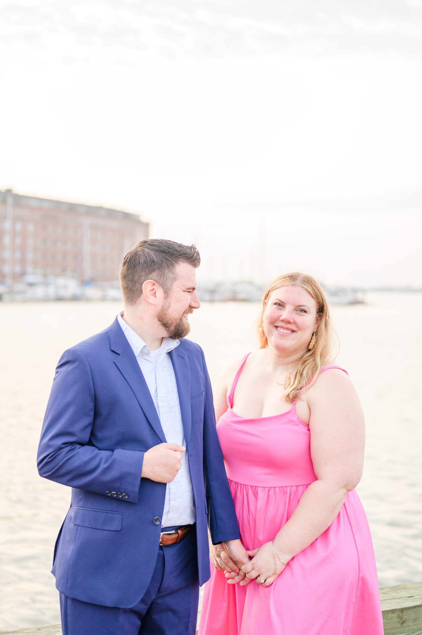 Engaged couple at Fells Point Waterfront for their sunrise engagement session in Baltimore, Maryland photographed by Baltimore Wedding Photographer Cait Kramer Photography.