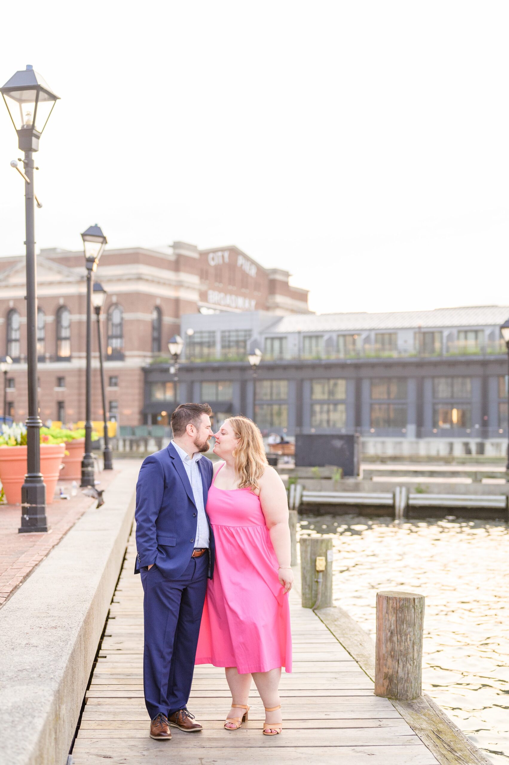 Engaged couple at Fells Point Waterfront for their sunrise engagement session in Baltimore, Maryland photographed by Baltimore Wedding Photographer Cait Kramer Photography.