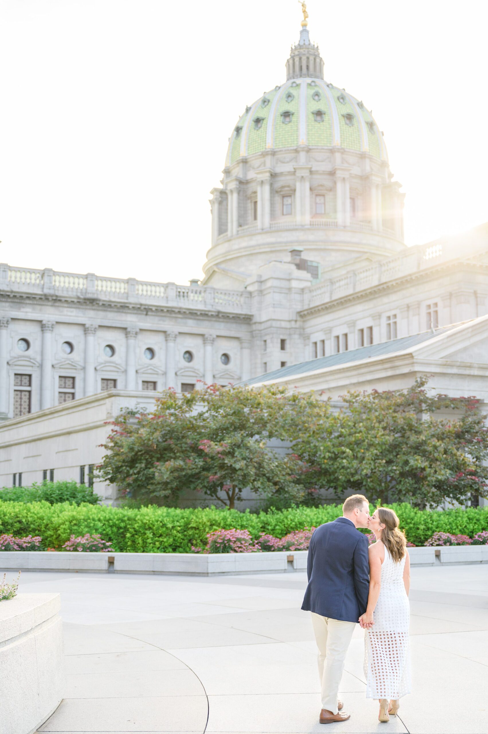 Engaged couple at the Pennsylvania State Capitol for their summer engagement session photographed by Baltimore Wedding Photographer Cait Kramer Photography.