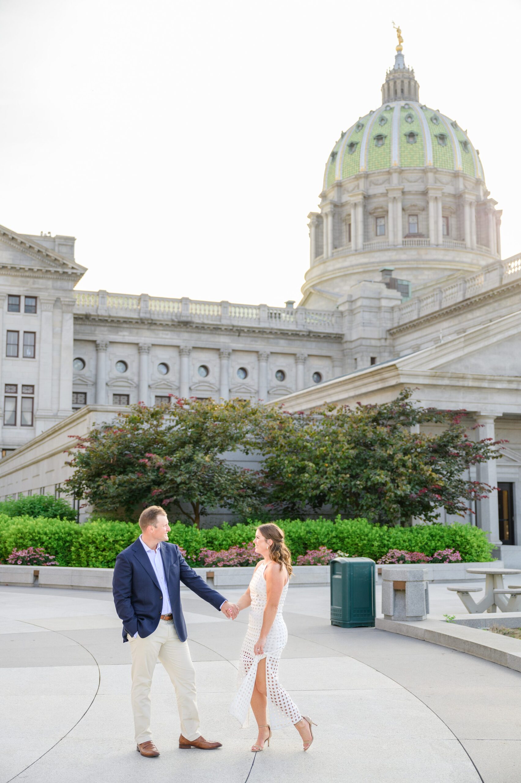 Engaged couple at the Pennsylvania State Capitol for their summer engagement session photographed by Baltimore Wedding Photographer Cait Kramer Photography.