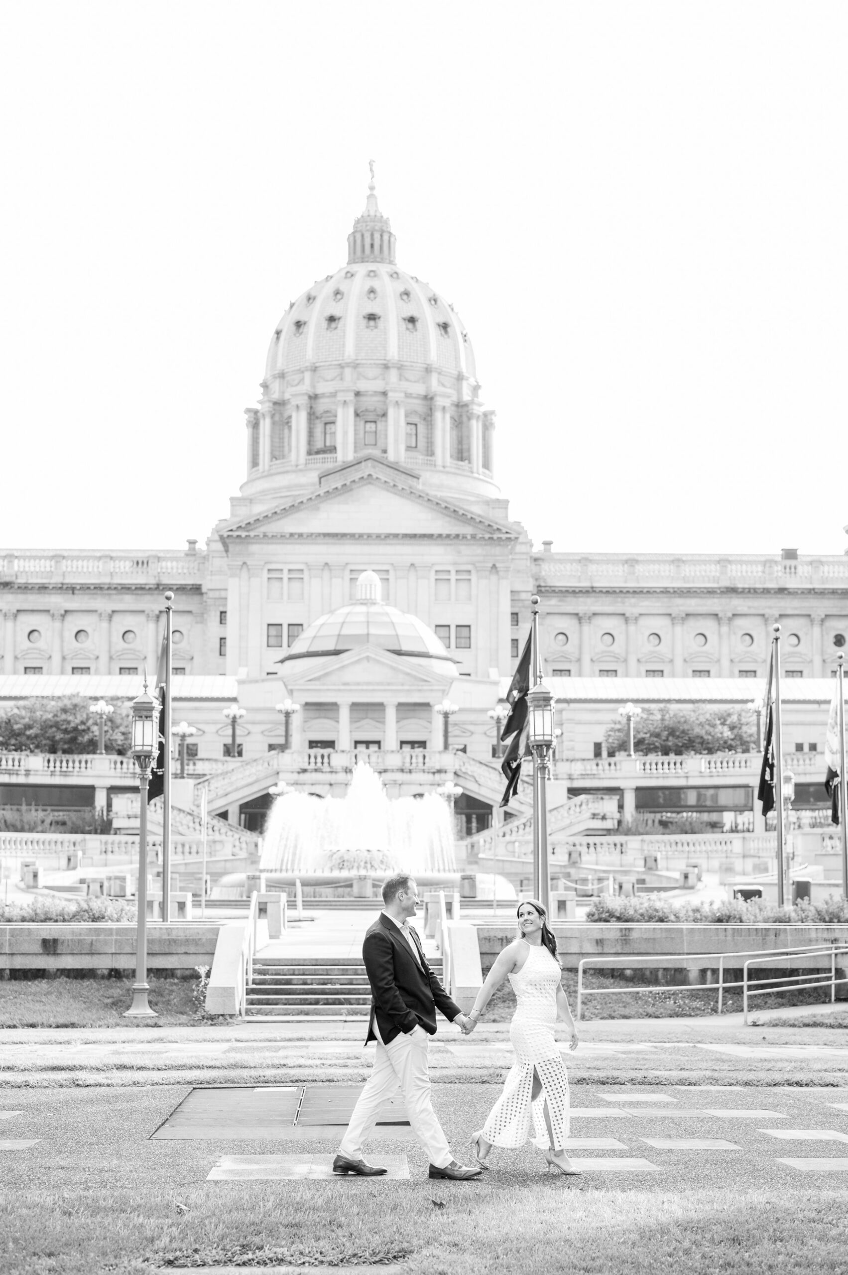 Engaged couple at the Pennsylvania State Capitol for their summer engagement session photographed by Baltimore Wedding Photographer Cait Kramer Photography.