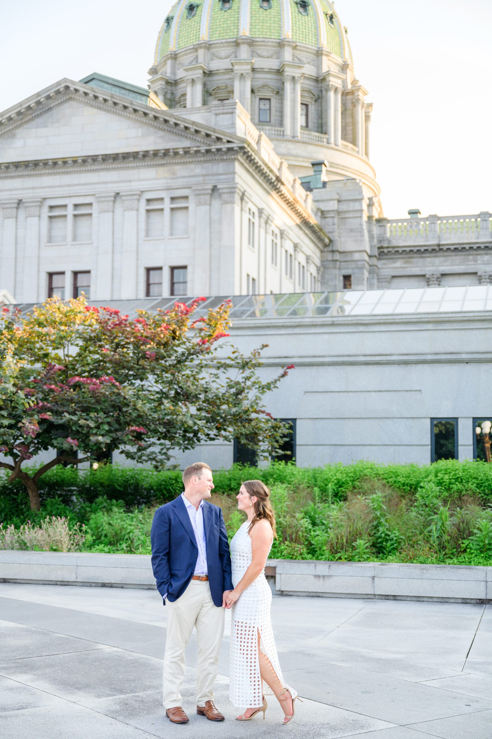 Engaged couple at the Pennsylvania State Capitol for their summer engagement session photographed by Baltimore Wedding Photographer Cait Kramer Photography.