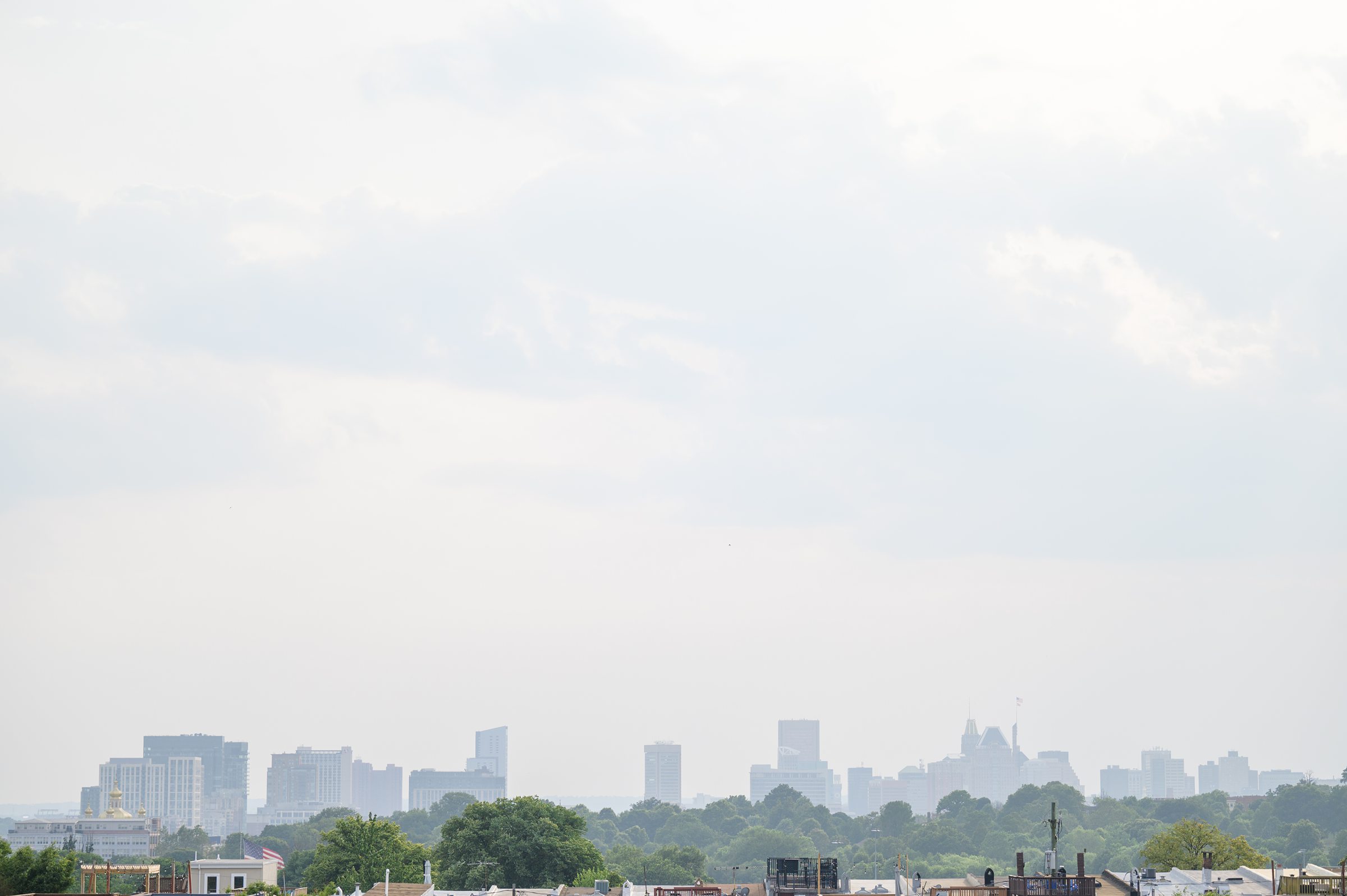 Sarah and Brenton's surprise proposal at their apartment rooftop in Baltimore, Maryland photographed by Baltimore Wedding Photographer Cait Kramer.