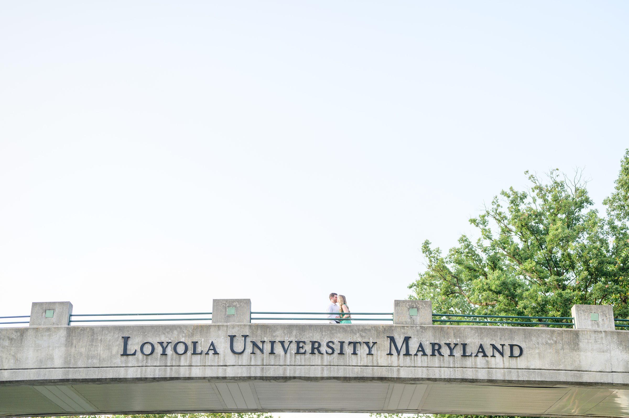 Engaged couple at the Loyola University Maryland campus for their summer engagement session in Baltimore, MD photographed by Baltimore Wedding Photographer Cait Kramer Photography