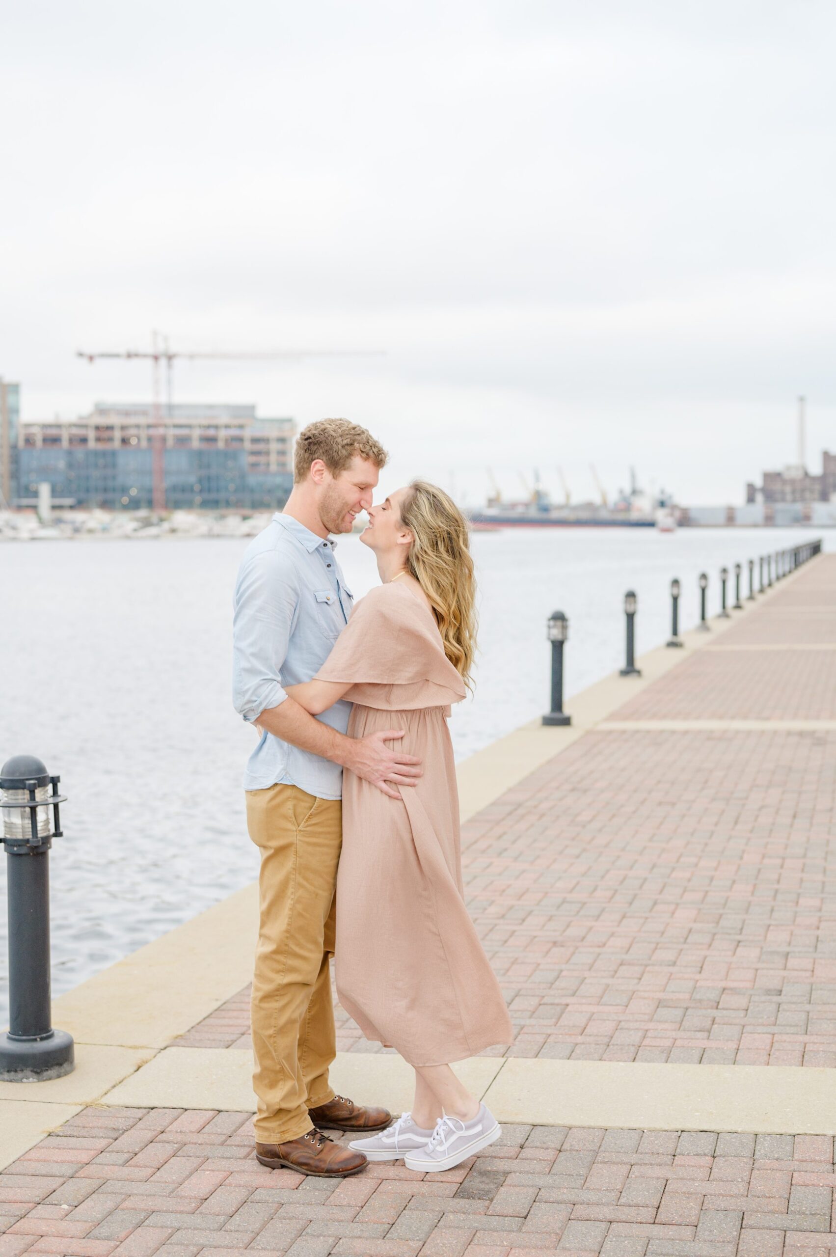 Pregnancy announcement photos at the Baltimore Inner Harbor photographed by Baltimore Maternity Photographer Cait Kramer.