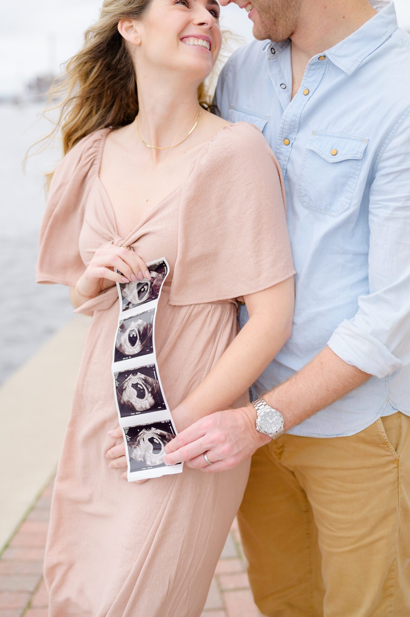 Pregnancy announcement photos at the Baltimore Inner Harbor photographed by Baltimore Maternity Photographer Cait Kramer.