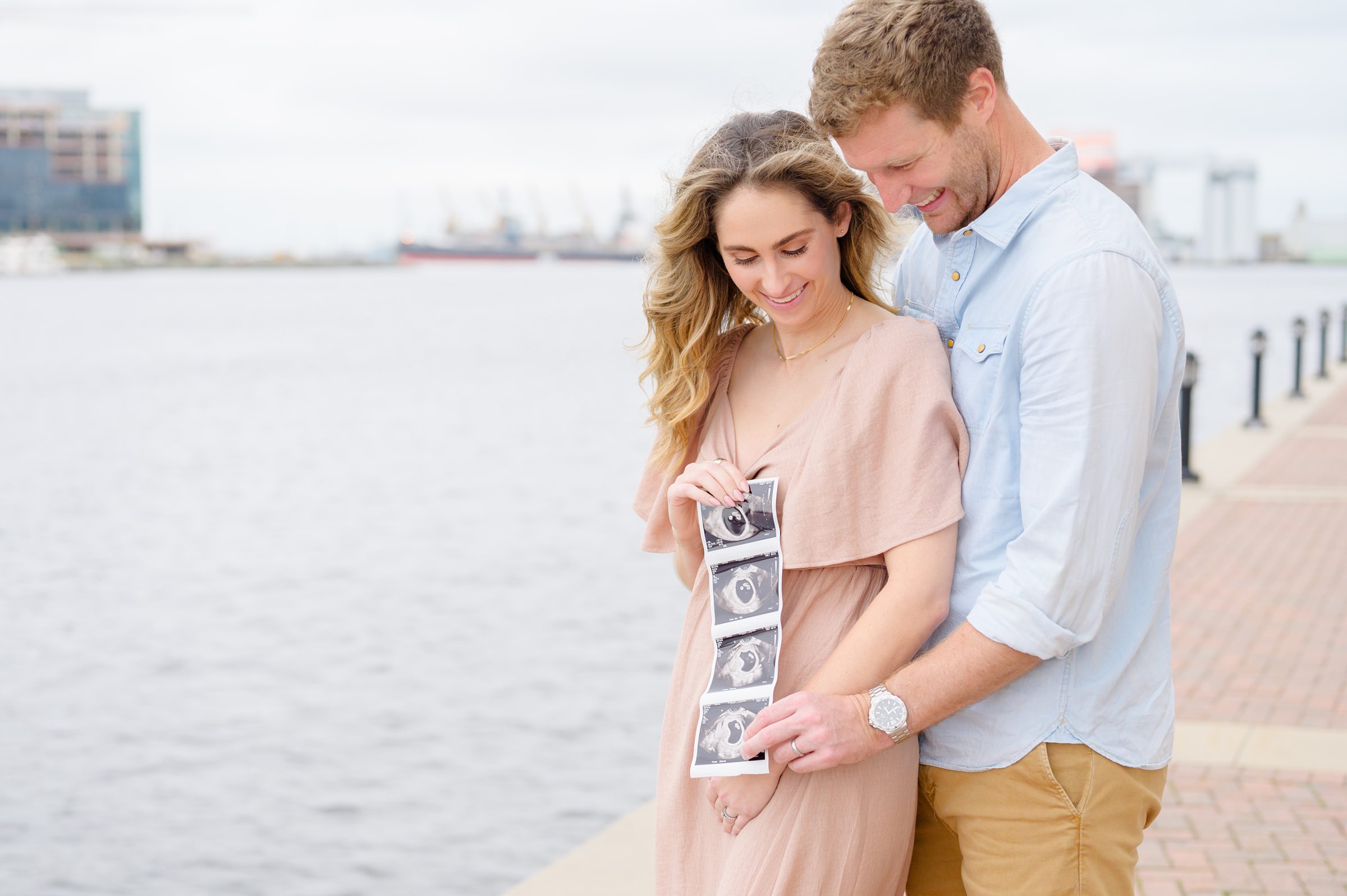 Pregnancy announcement photos at the Baltimore Inner Harbor photographed by Baltimore Maternity Photographer Cait Kramer.