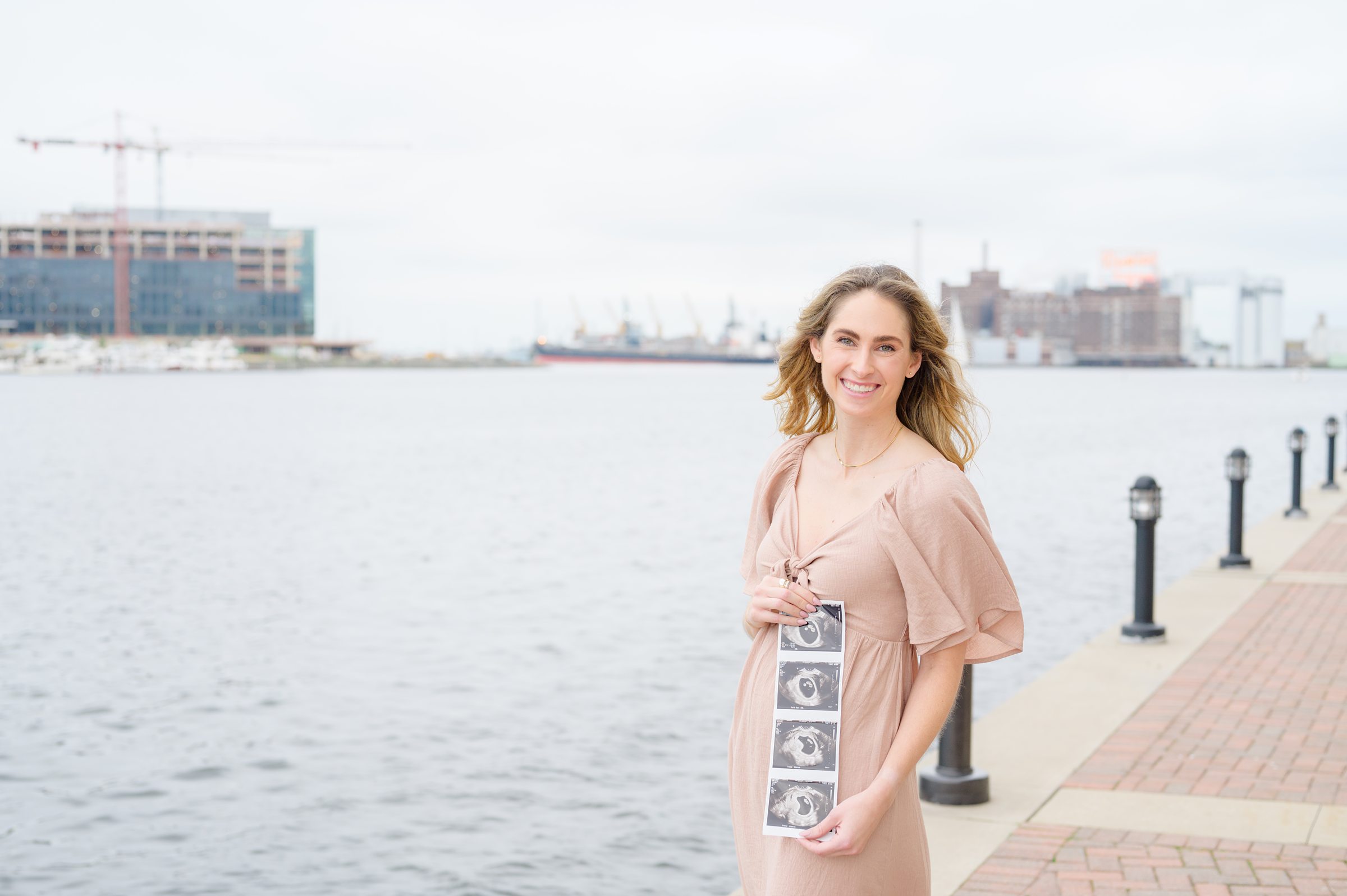 Pregnancy announcement photos at the Baltimore Inner Harbor photographed by Baltimore Maternity Photographer Cait Kramer.