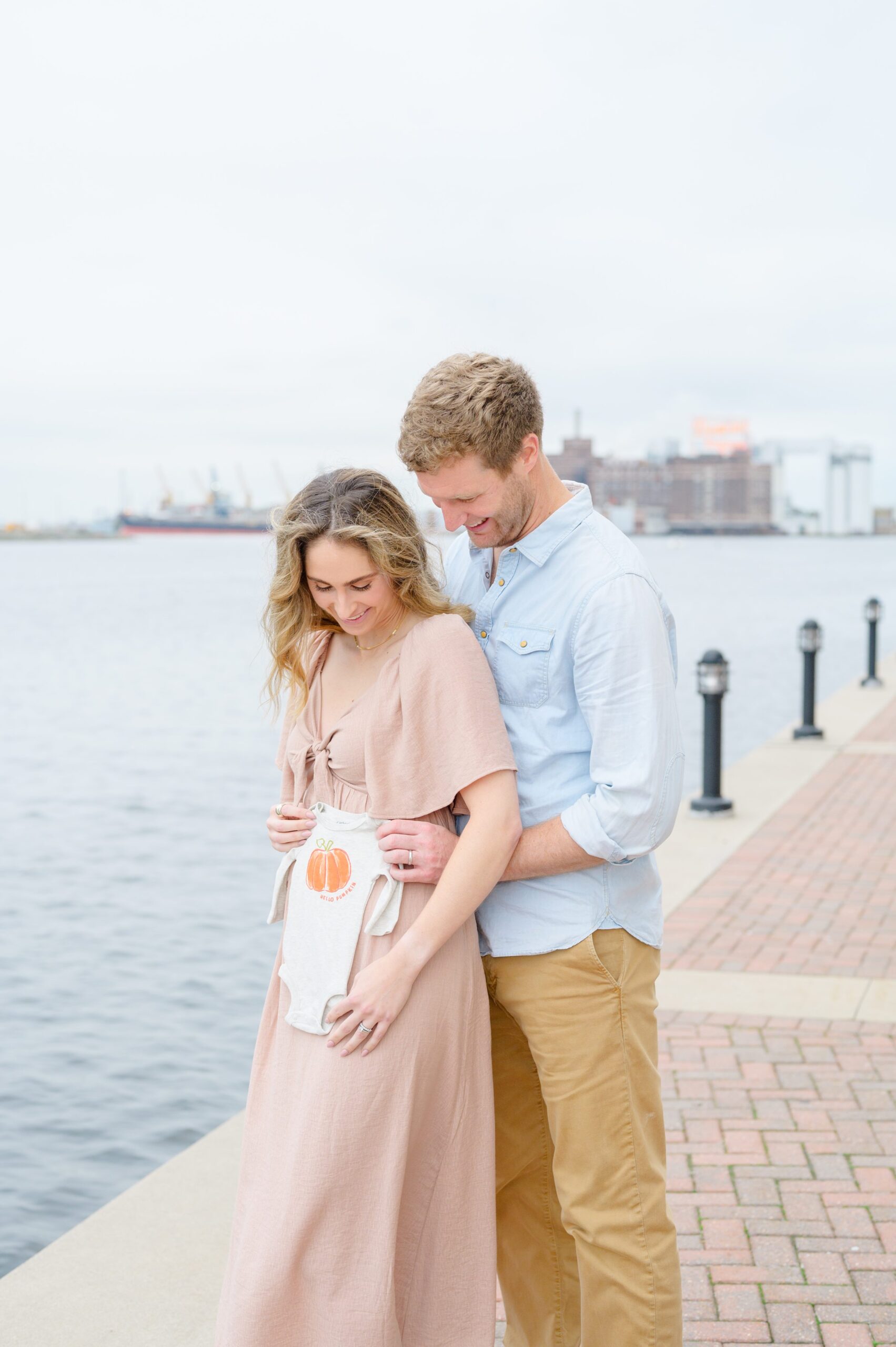 Pregnancy announcement photos at the Baltimore Inner Harbor photographed by Baltimore Maternity Photographer Cait Kramer.