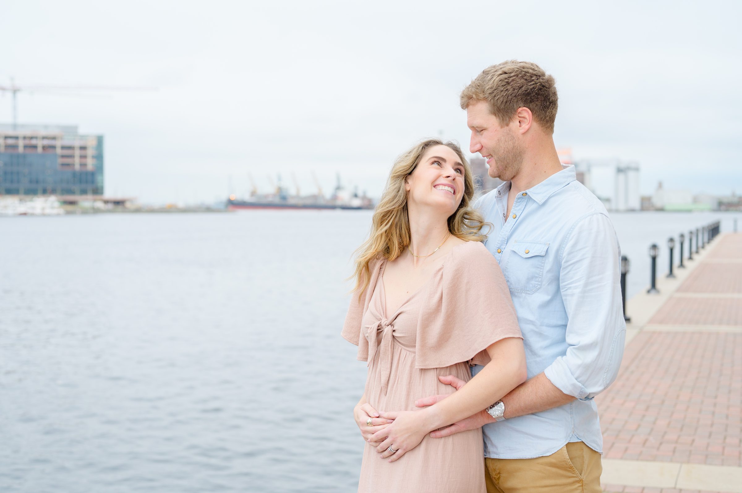 Pregnancy announcement photos at the Baltimore Inner Harbor photographed by Baltimore Maternity Photographer Cait Kramer.